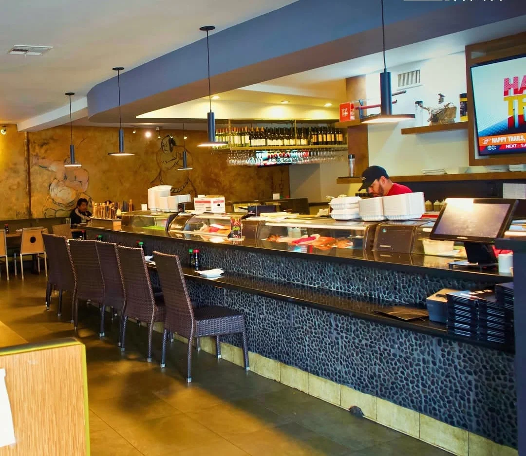 Modern sushi restaurant interior with a sleek bar