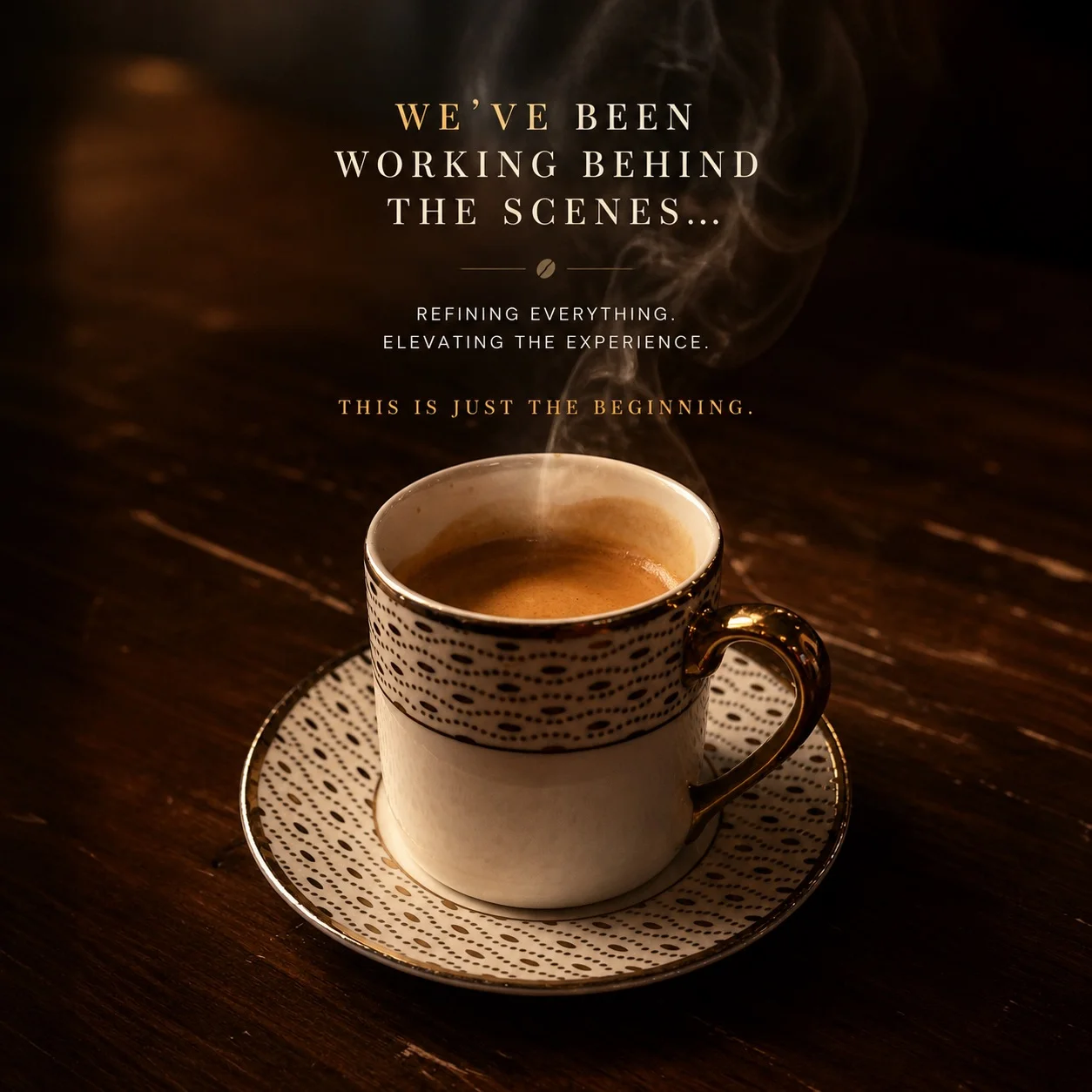 A steaming cup of coffee on a decorative saucer against a wooden table.