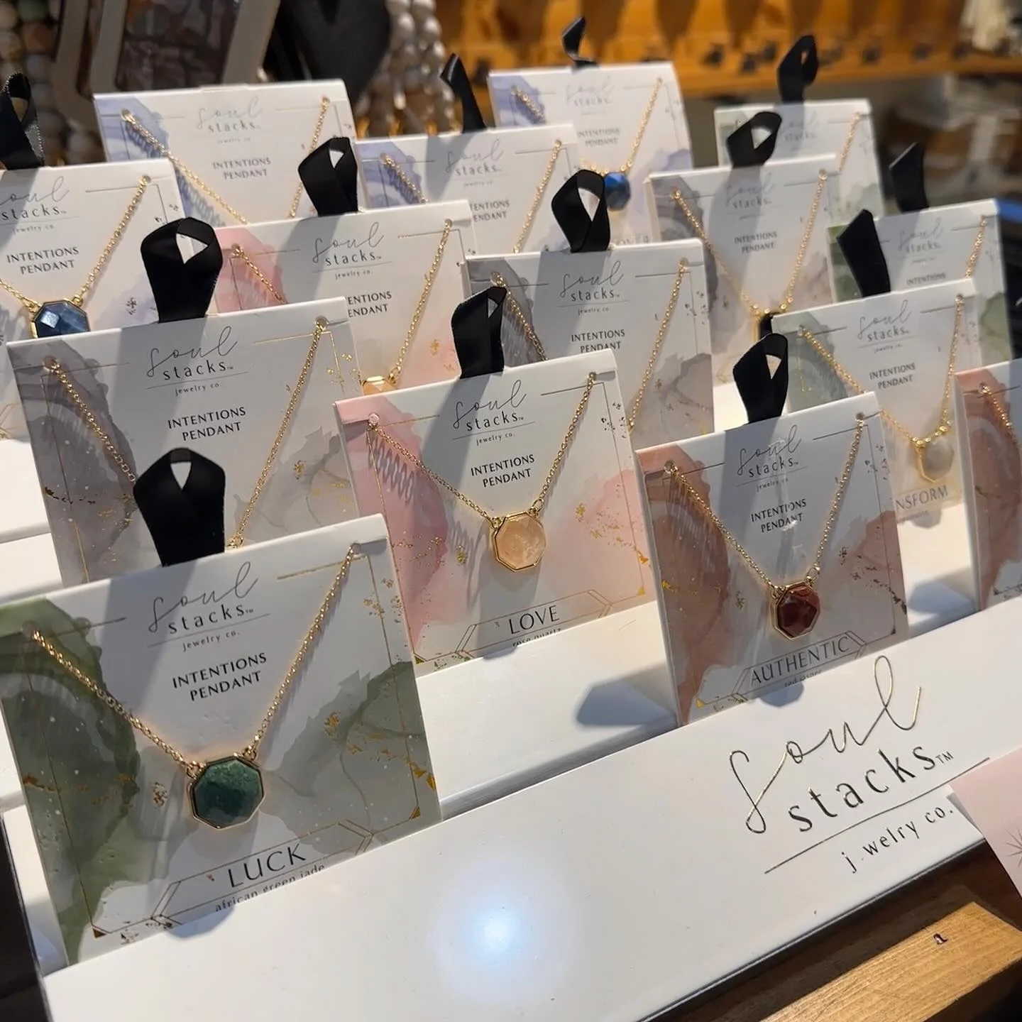 Display of Soul Stacks intention pendants in various designs
