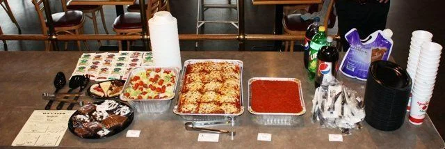 A delicious meal featuring a fresh salad with cheese, breadsticks, and a drink on a table in a casual dining setting.
