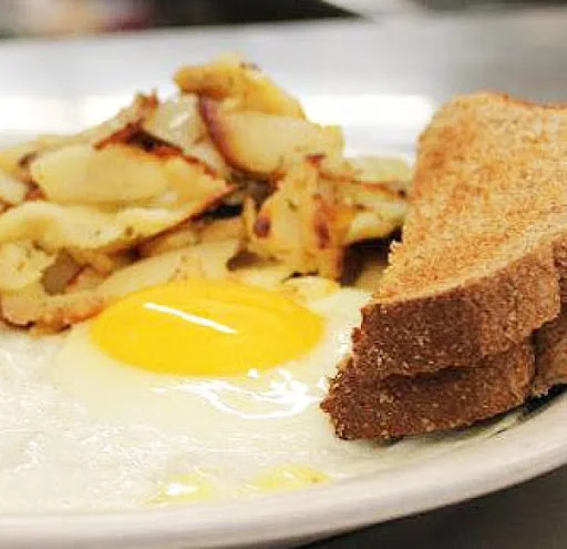 Classic American breakfast with eggs, toast, and hash browns