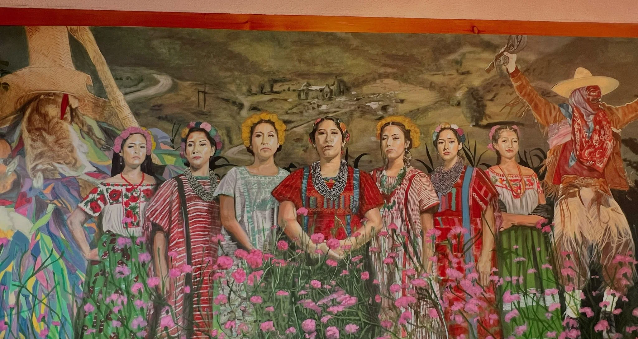 Vibrant mural depicting traditional Mexican women in colorful attire