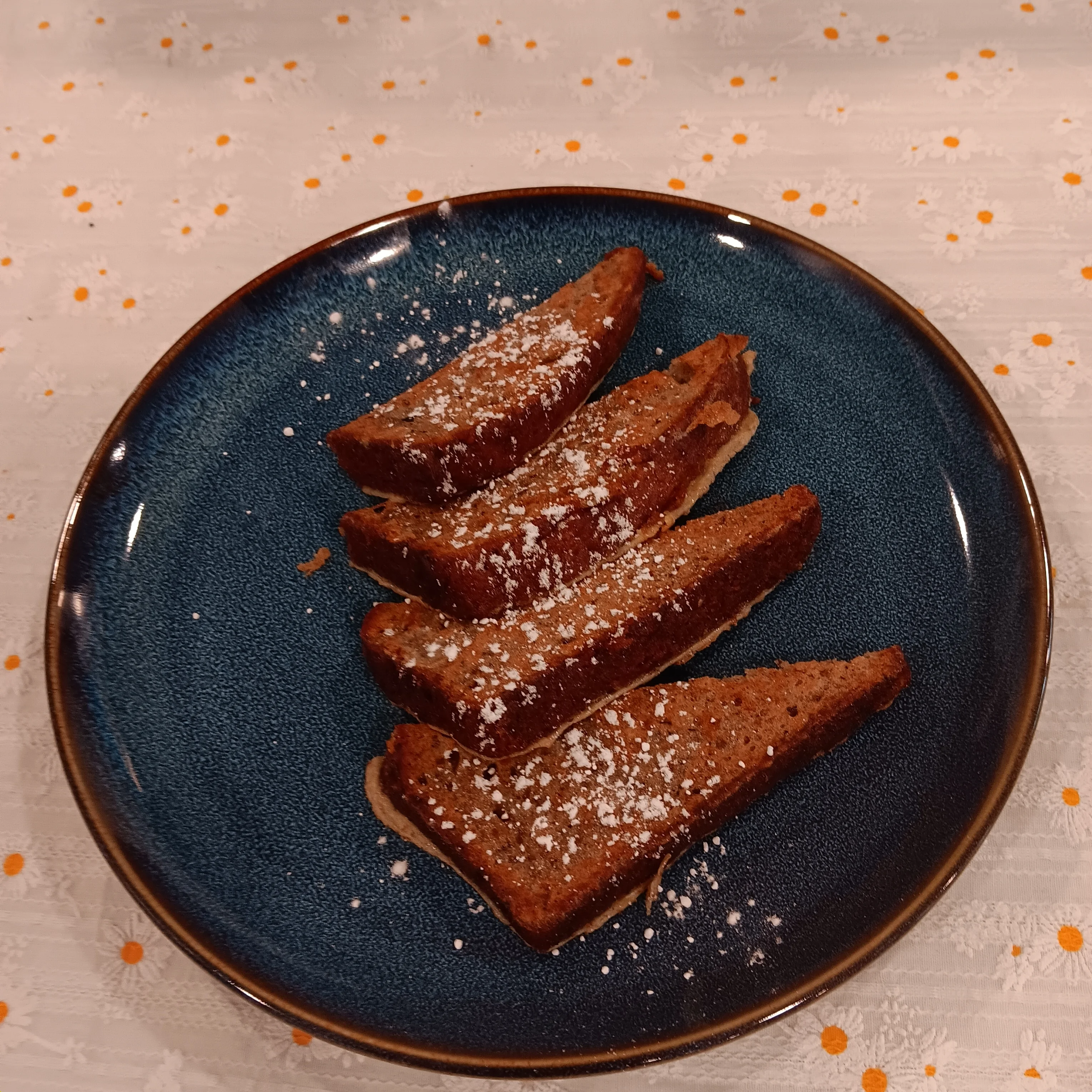 Sliced gingerbread cake dusted with powdered sugar