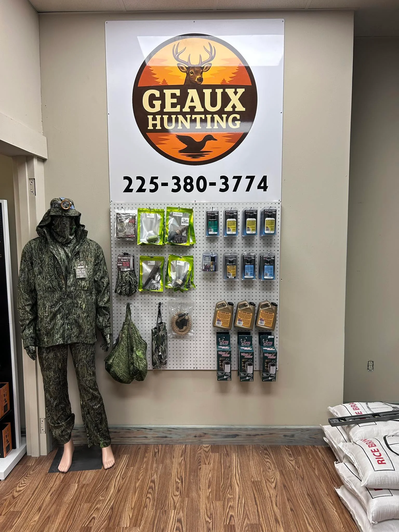 Hunting gear display with camouflage clothing and accessories