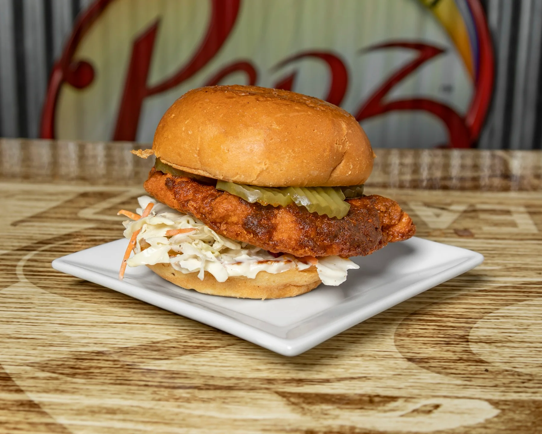 Nashville hot chicken sandwich with coleslaw and pickles on a brioche bun