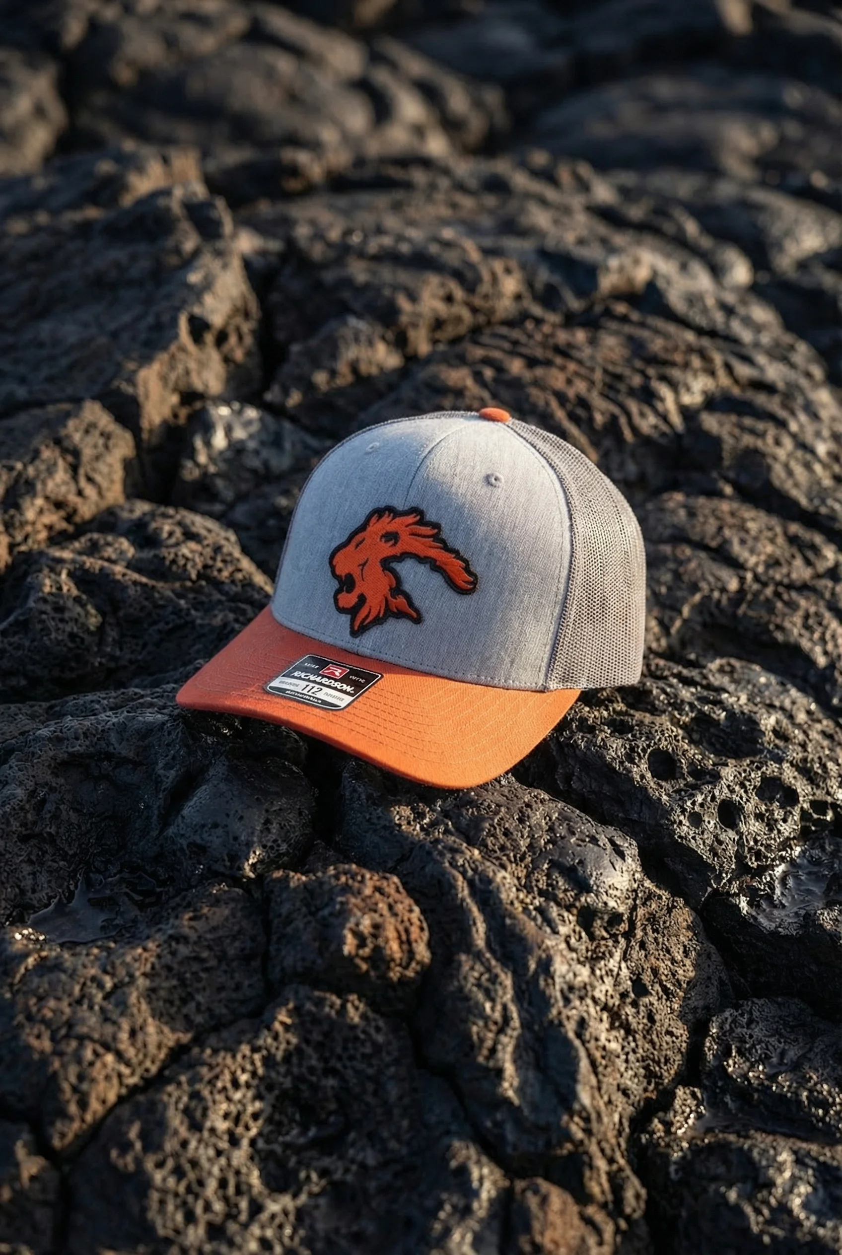 Stylish cap resting on textured lava rock surface