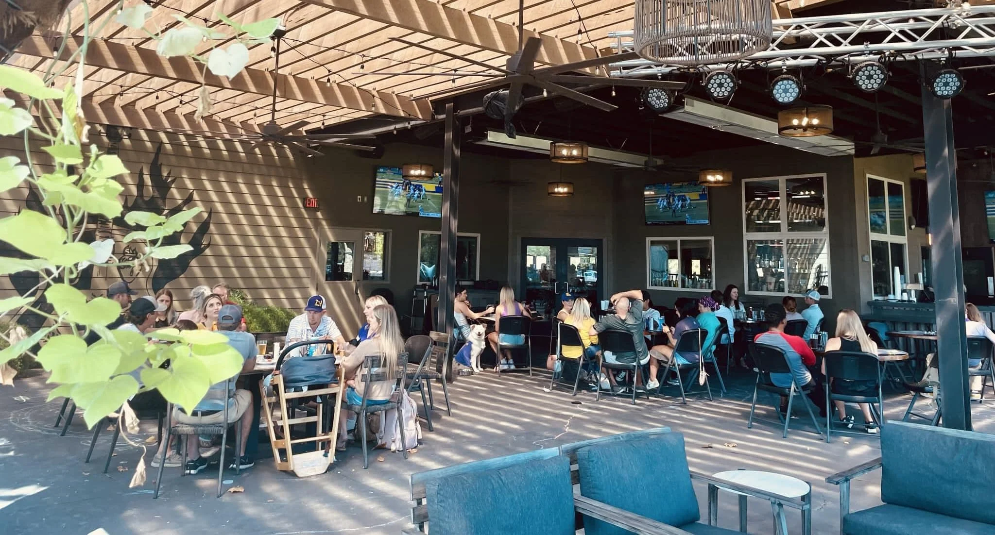 Outdoor dining area with patrons enjoying food and drinks