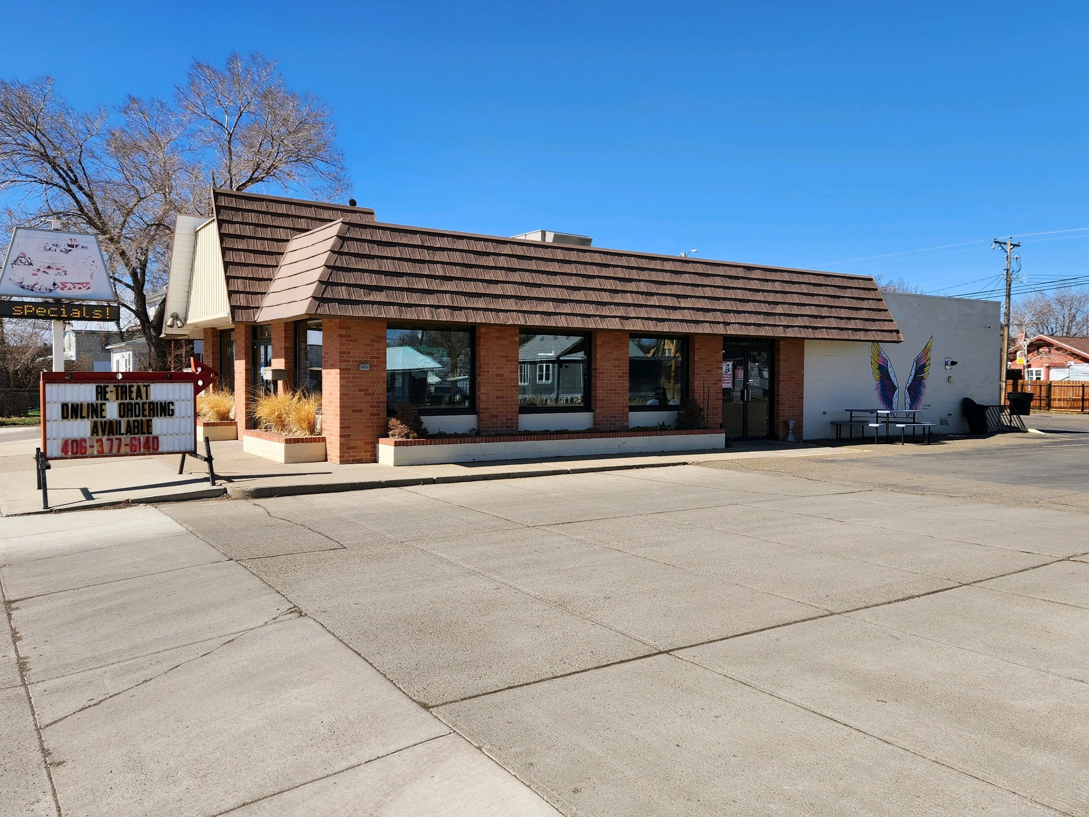 Charming restaurant exterior with a welcoming sign
