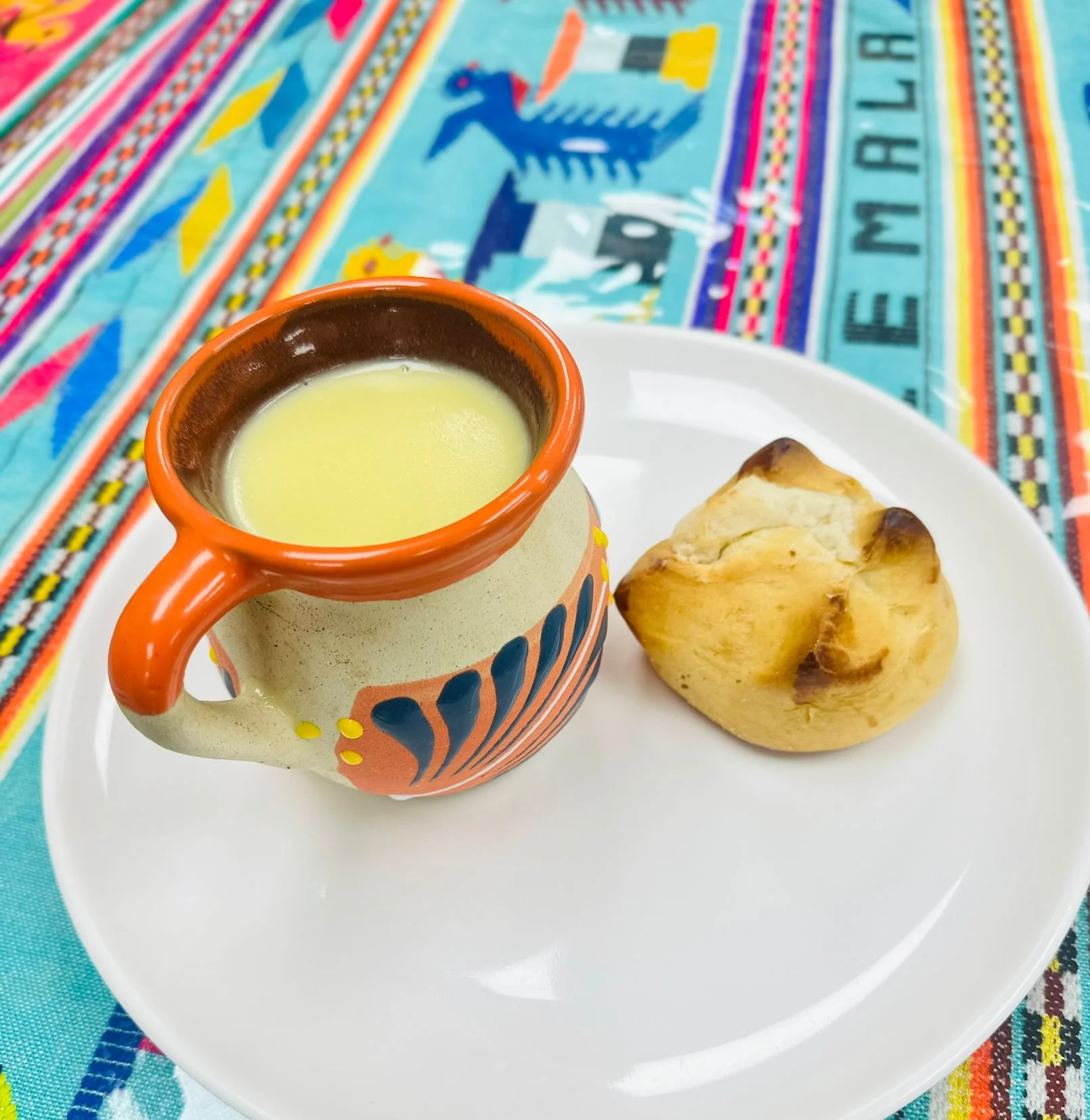 Traditional Mexican atole served with a sweet bread roll