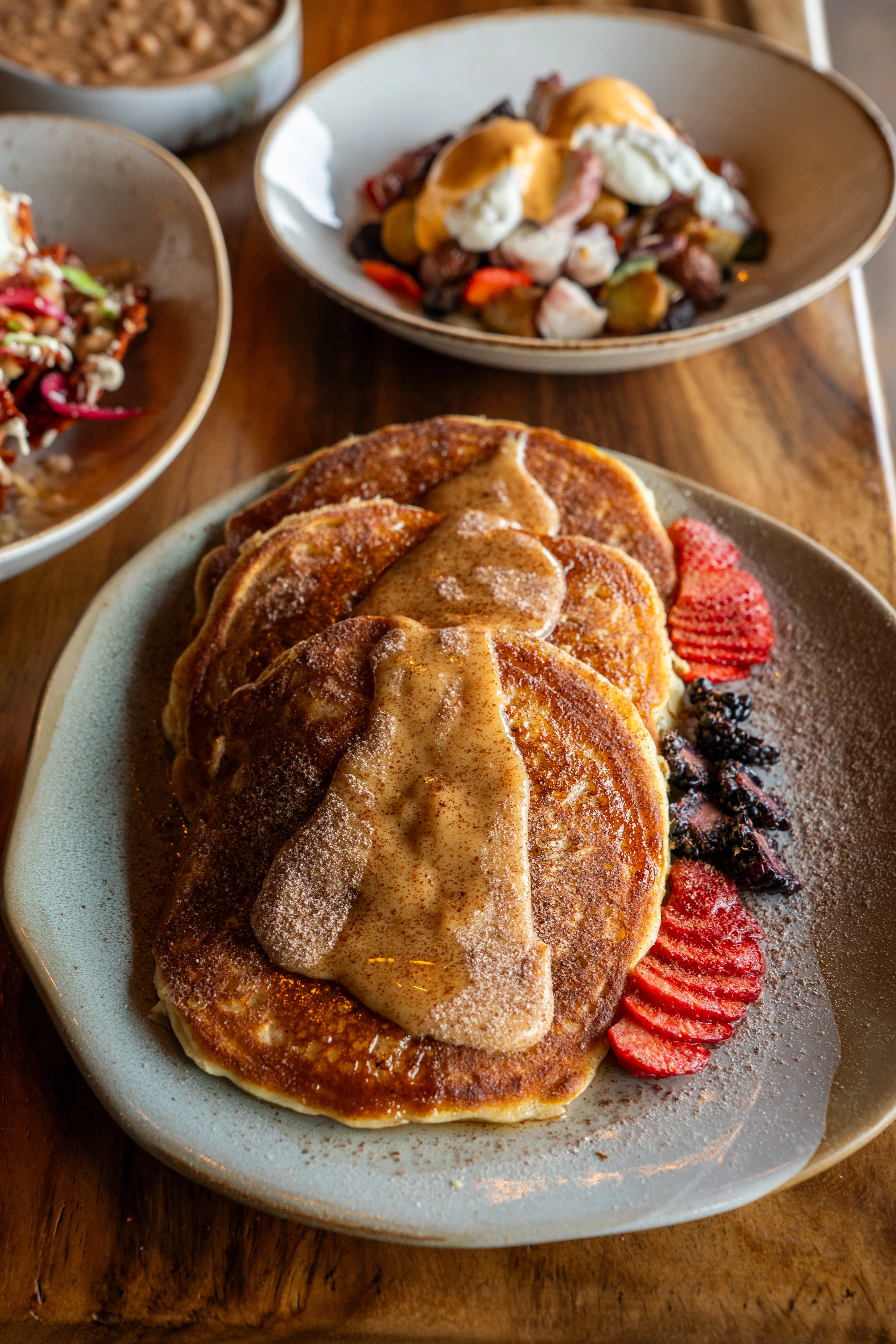Fluffy pancakes with cinnamon and fruit garnish