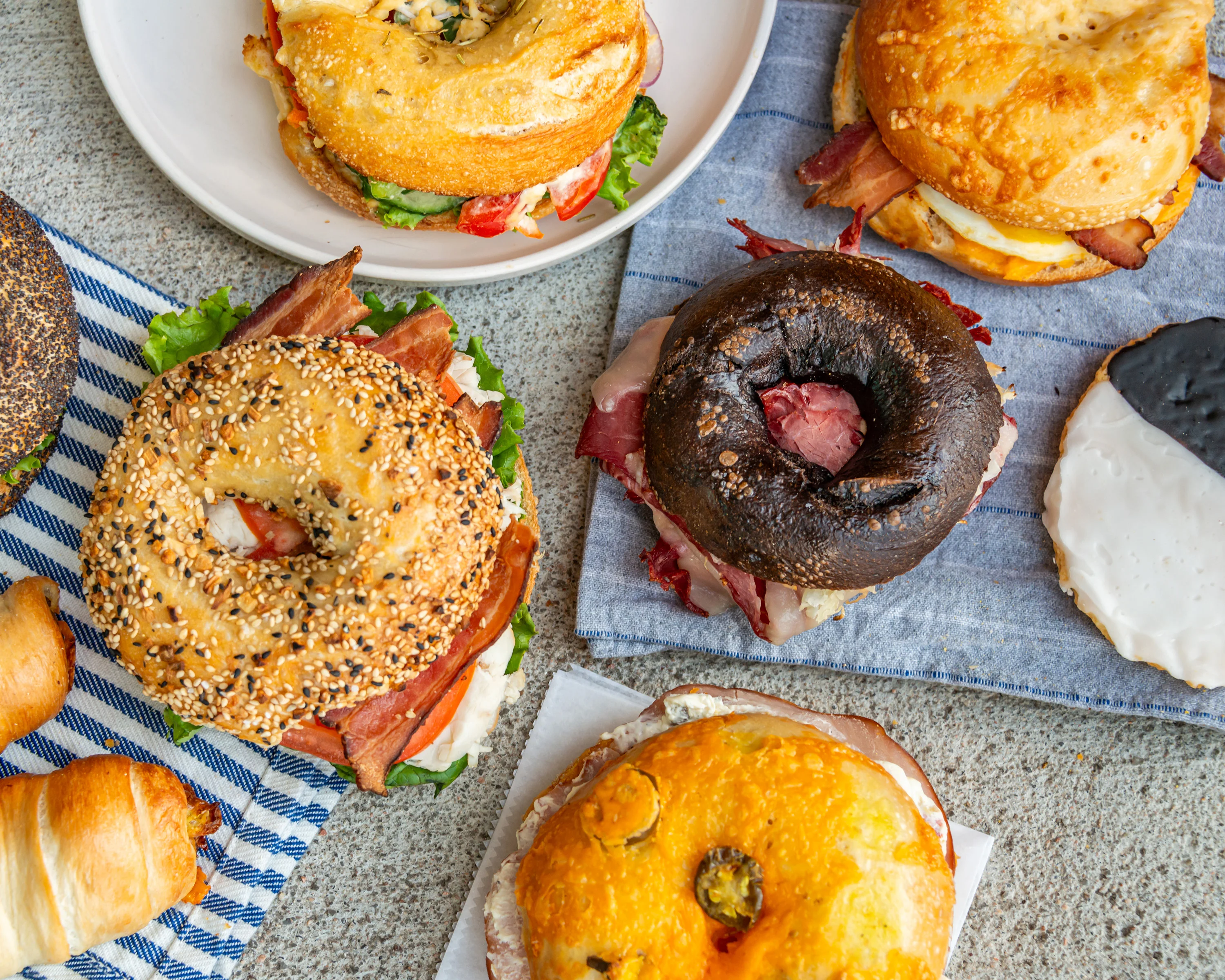 Assorted bagels with various fillings on a rustic table