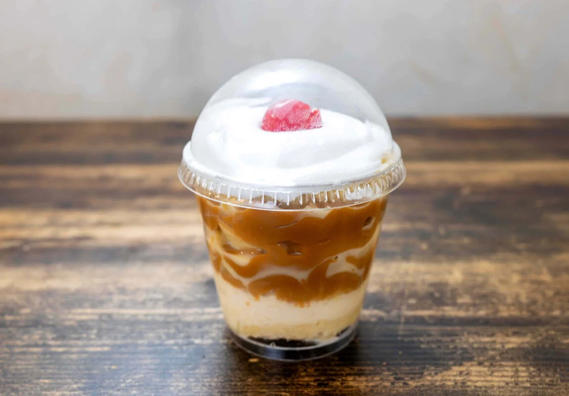 Delicious coffee dessert with whipped cream and cherry on top