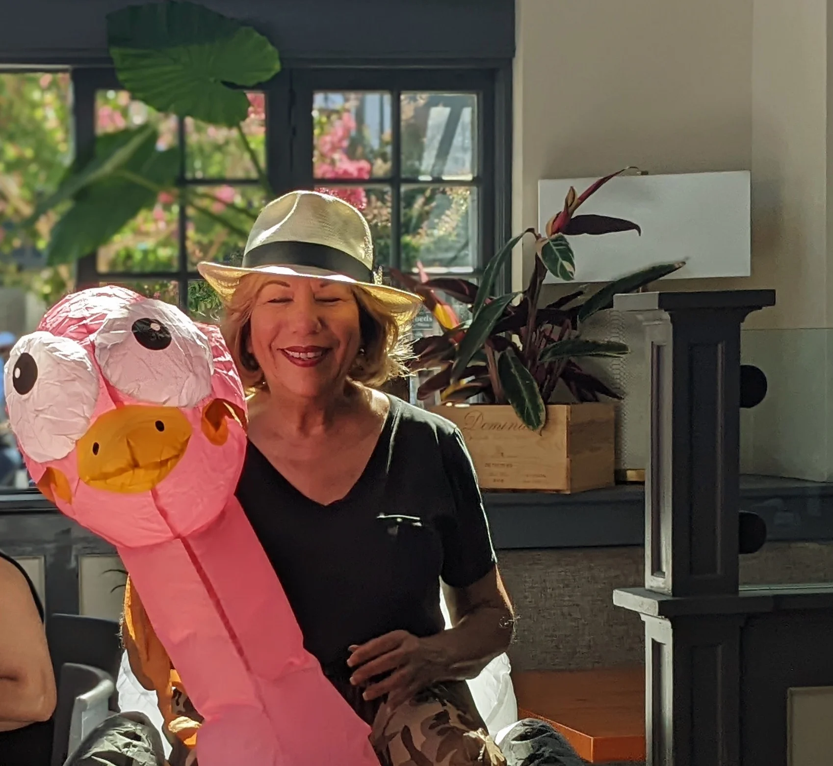 Woman in a restaurant with a fun inflatable flamingo costume