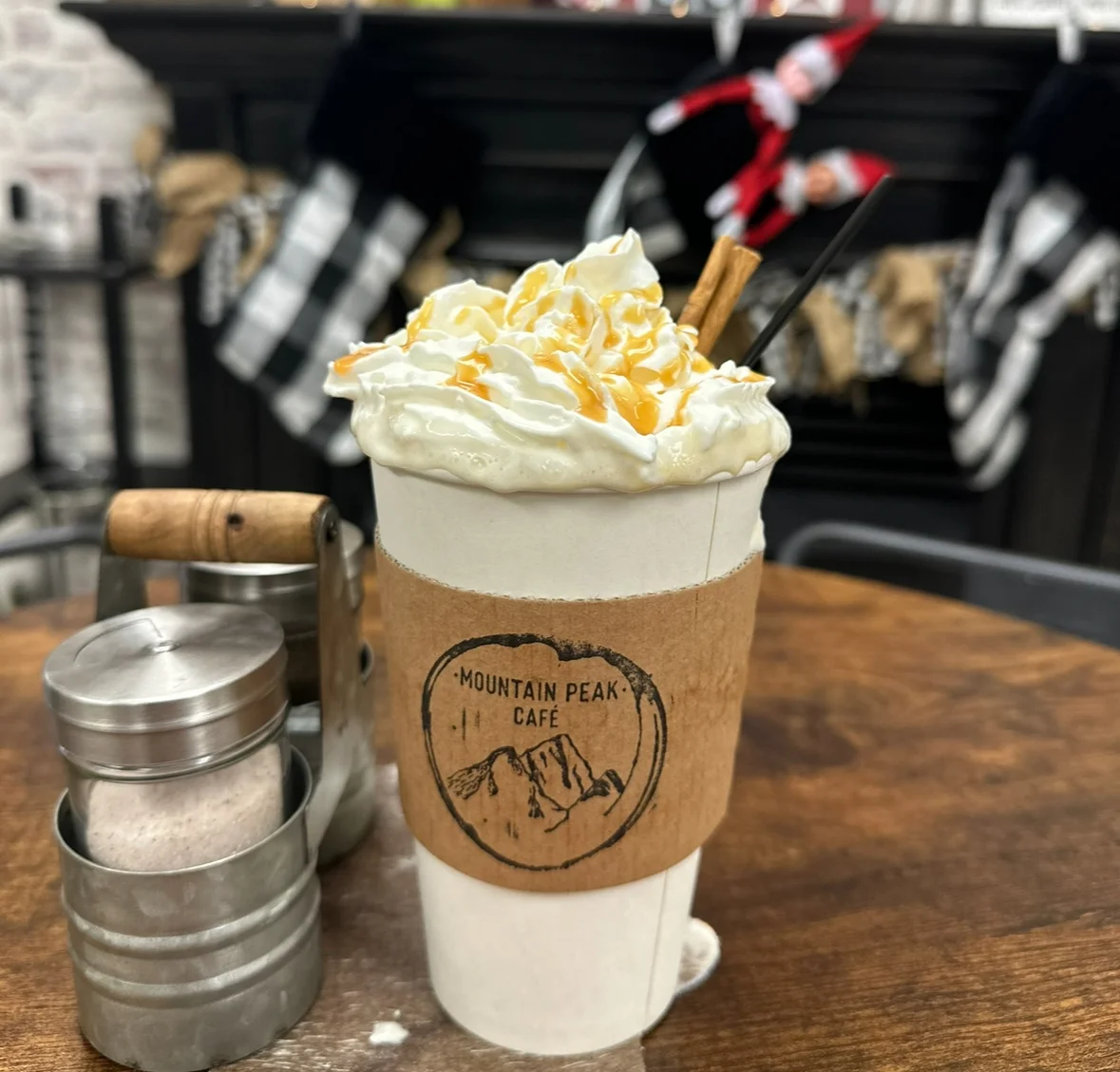 Caramel latte topped with whipped cream at a cozy café