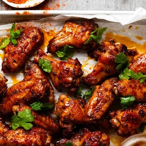 Crispy Asian-style chicken wings on a bed of lettuce