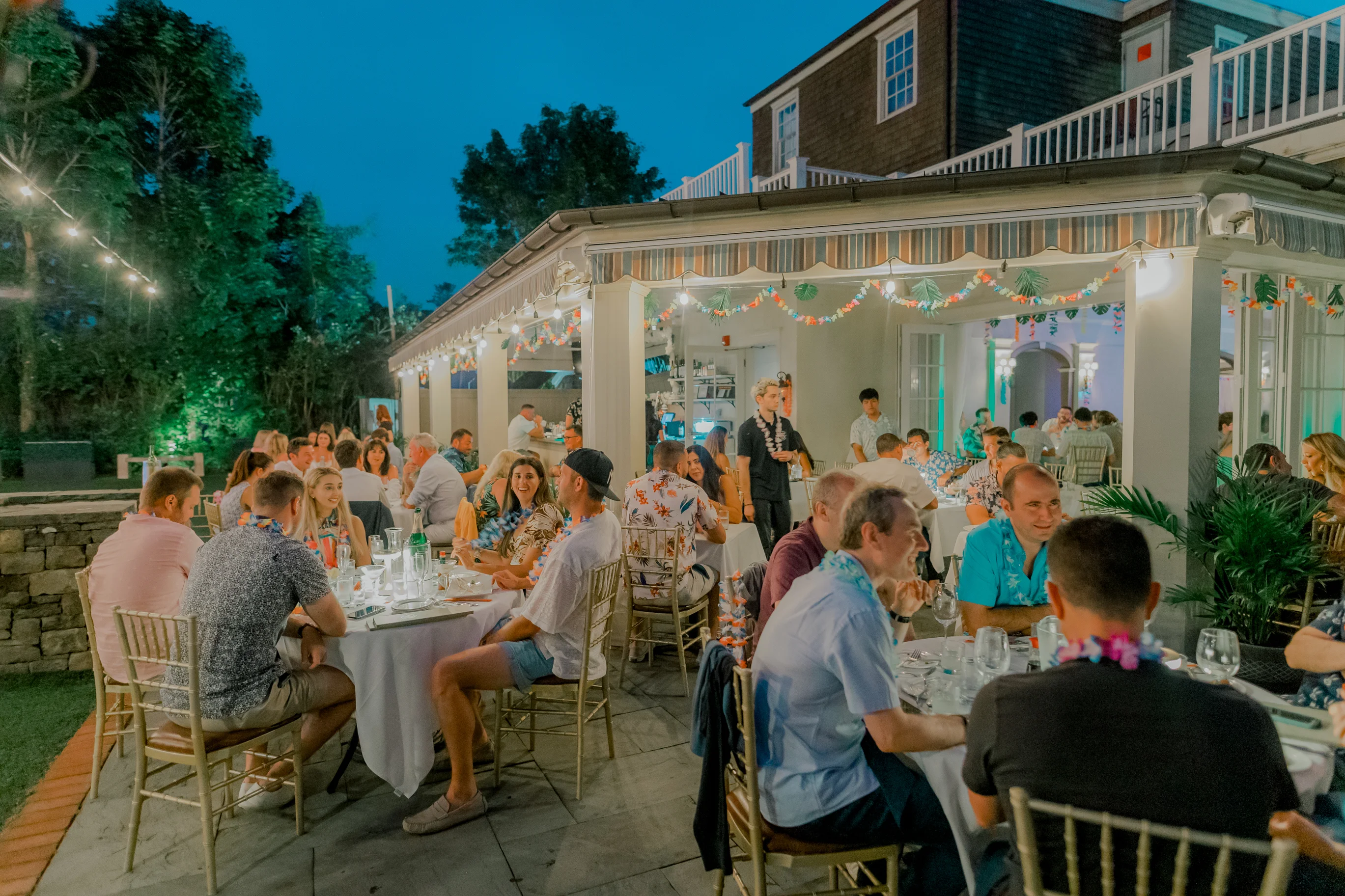 Outdoor dining scene with guests enjoying a festive atmosphere