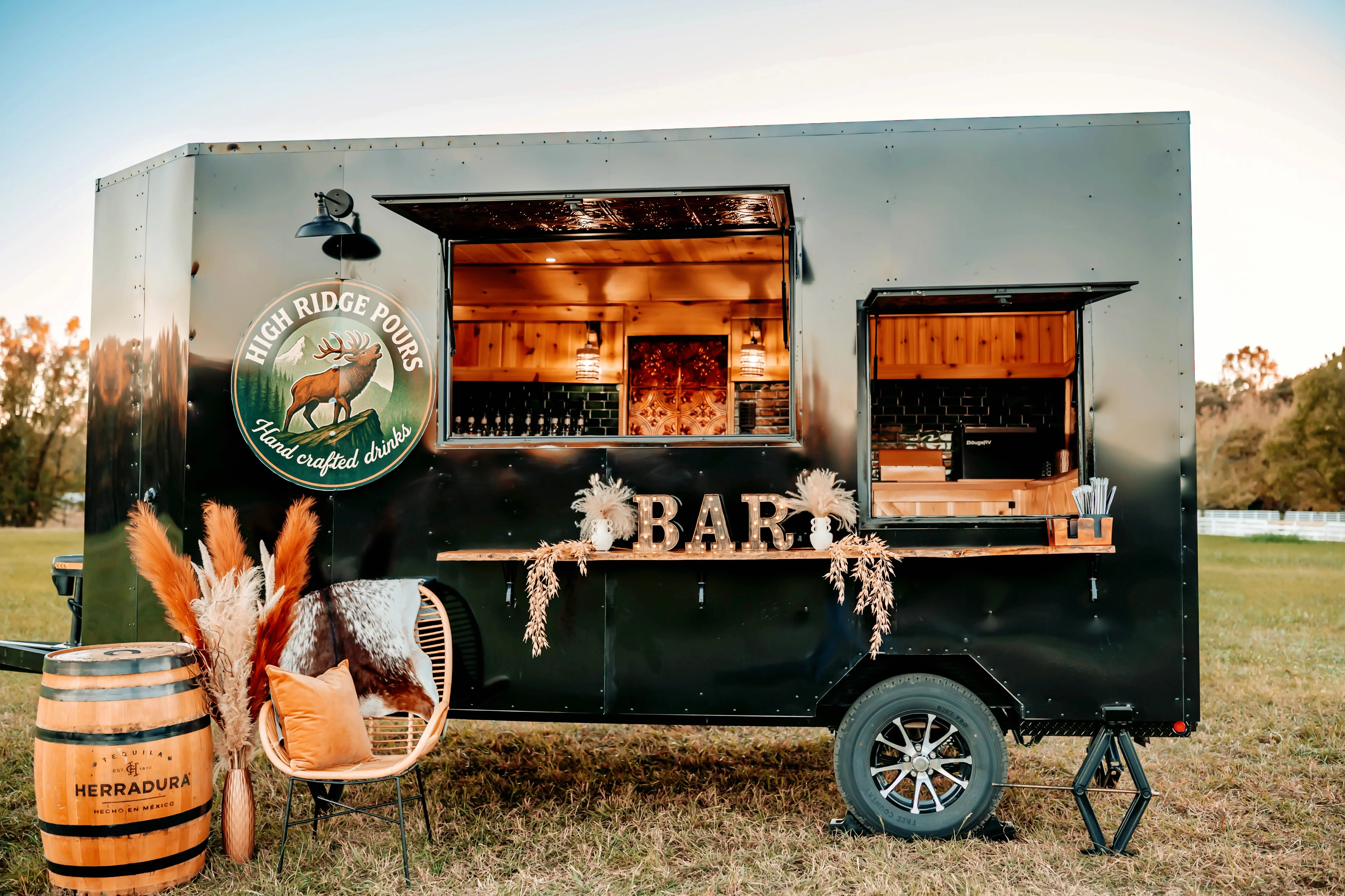 Mobile bar trailer with handcrafted drinks and rustic decor