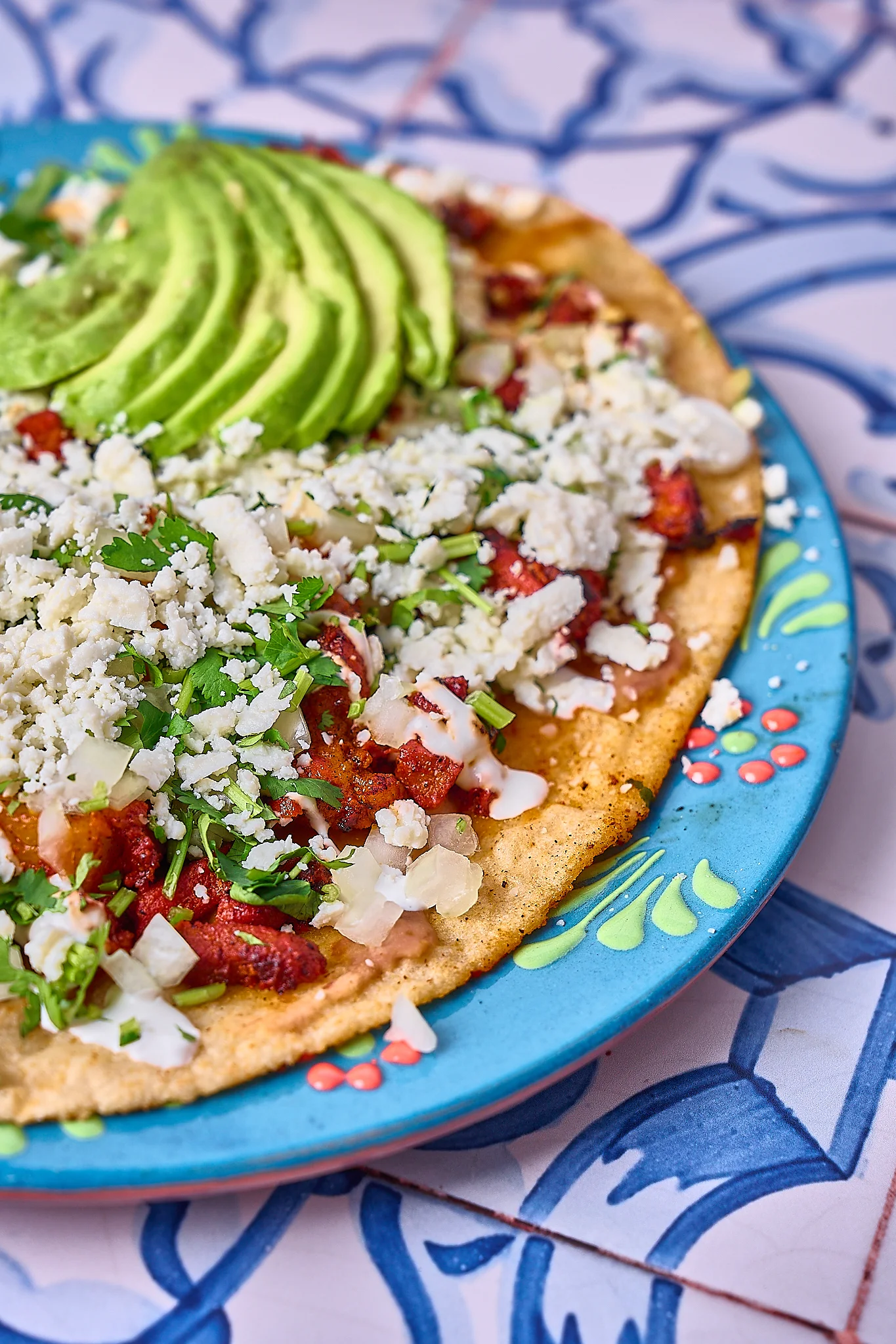 Delicious Mexican tacos topped with avocado and cheese
