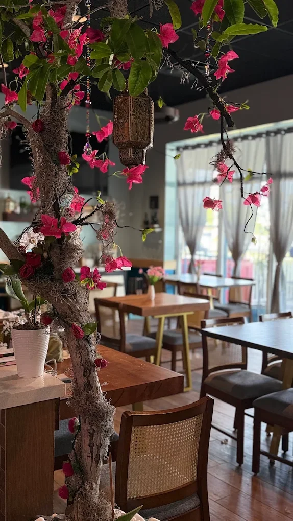 Charming restaurant interior with floral decor and wooden tables