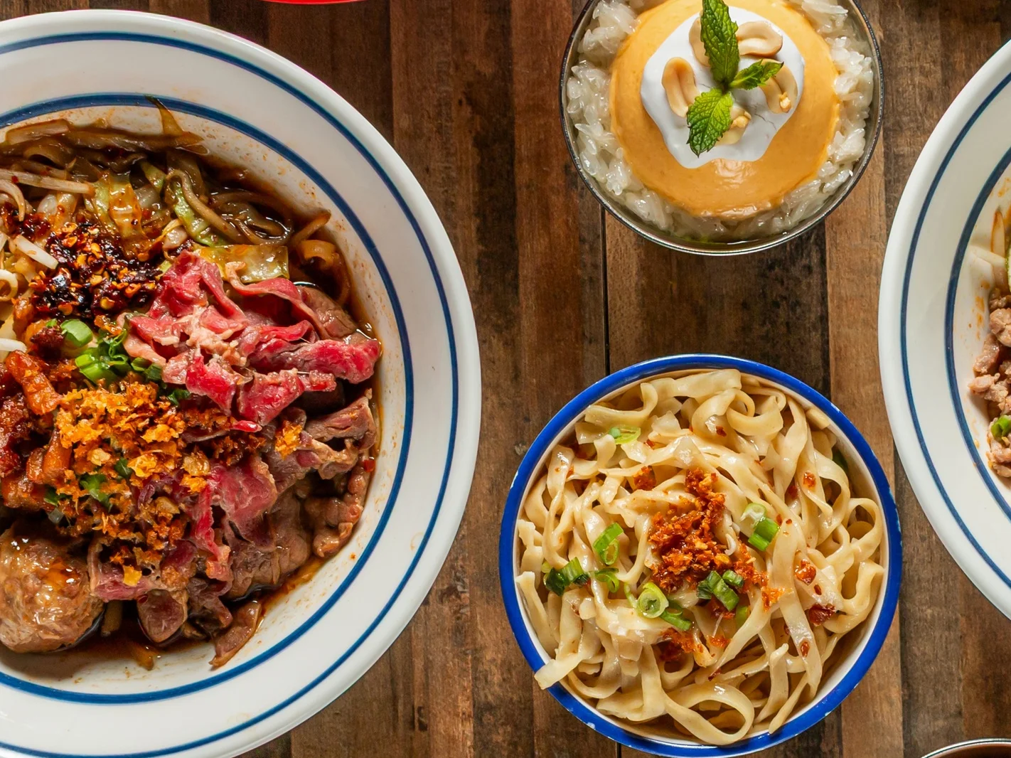 Assorted Thai dishes including pad thai and fried rice