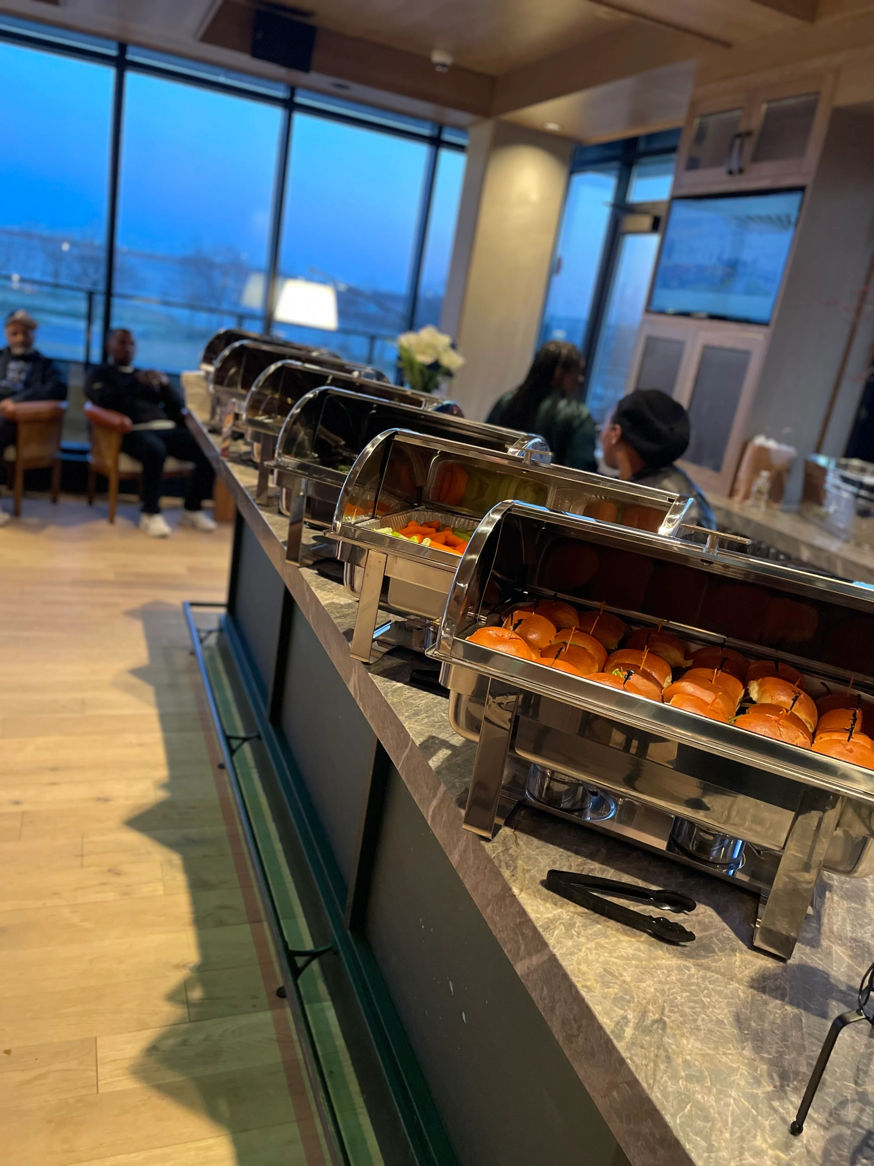 Buffet display with sliders and fresh fruit in a modern restaurant