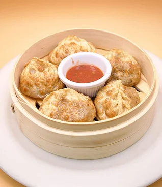 Delicious Nepali momo dumplings with dipping sauce