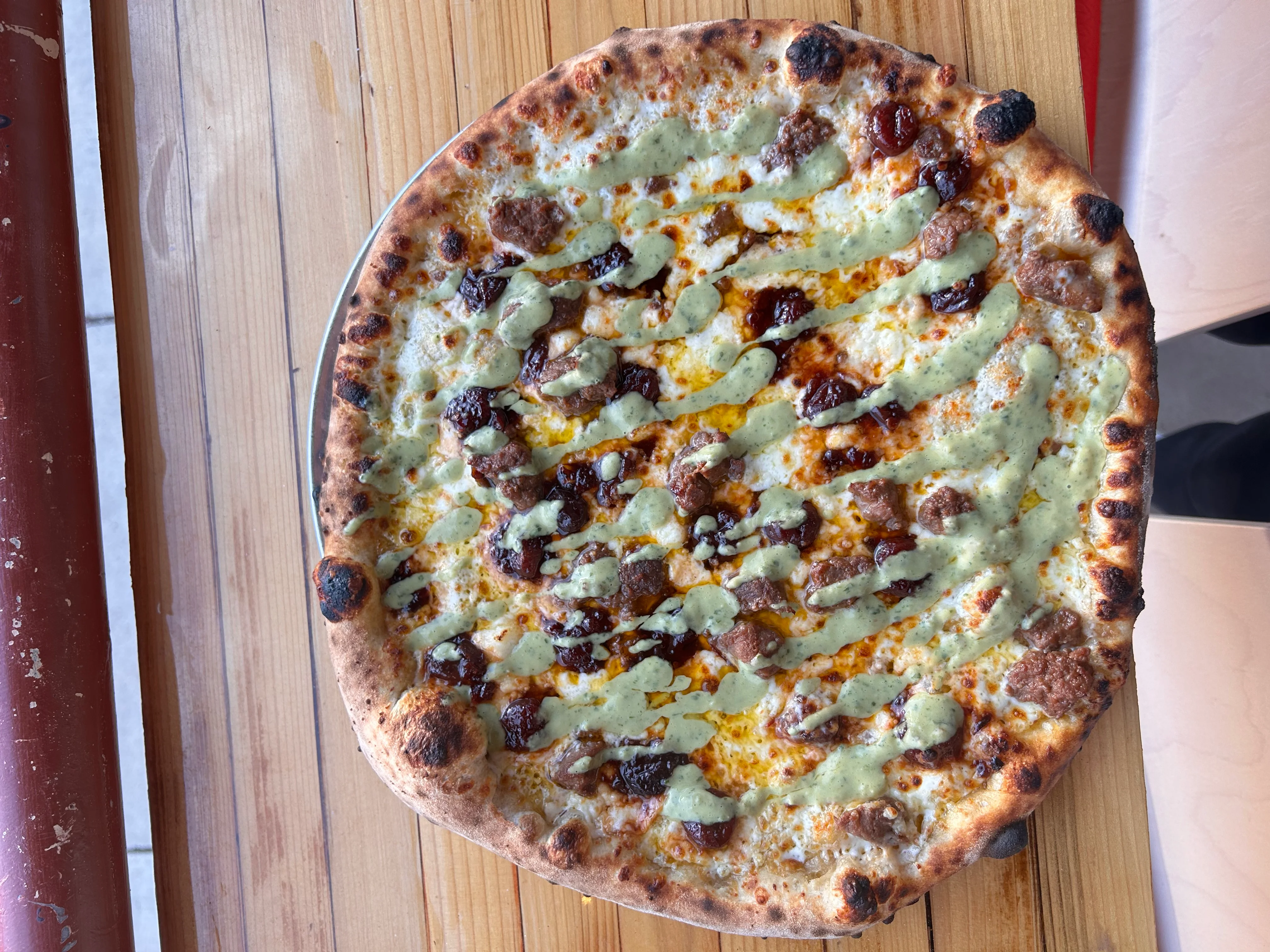 Gourmet pizza with unique toppings and drizzled sauce