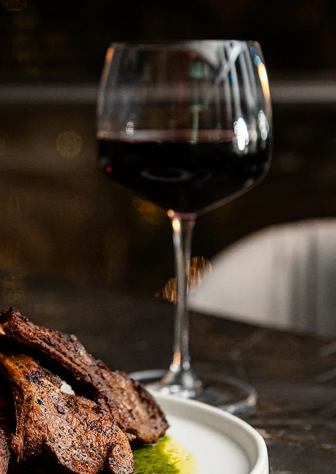 Grilled lamb chops with herb sauce in a fine dining setting