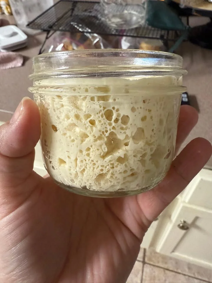 Active sourdough starter in a glass jar