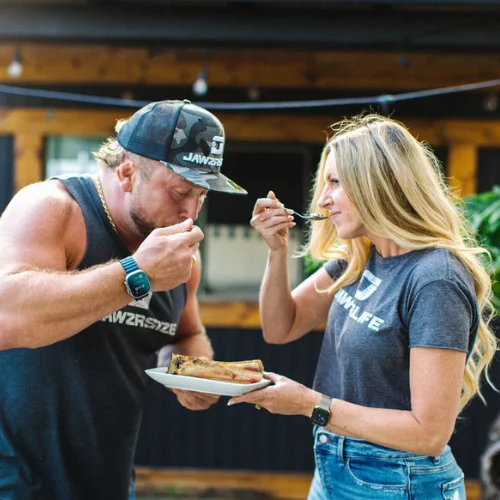 Couple enjoying BBQ ribs outdoors
