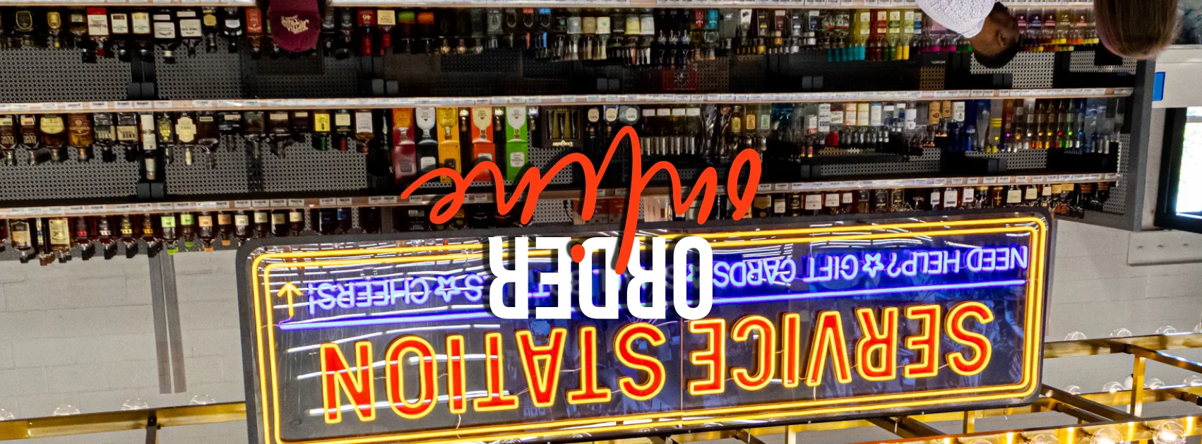 Service station with liquor shelves and neon sign
