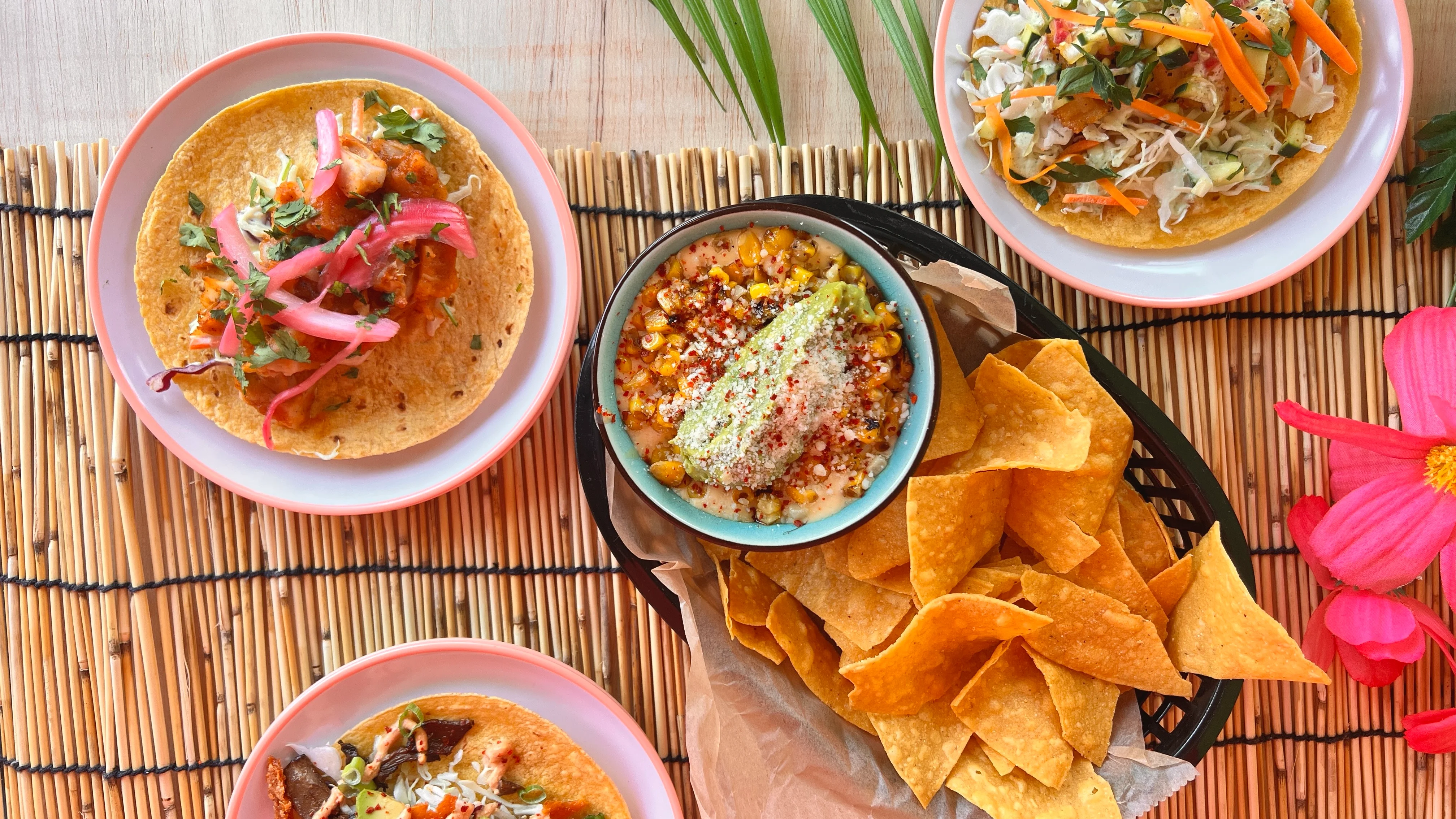 Colorful Mexican tacos with elote and tortilla chips