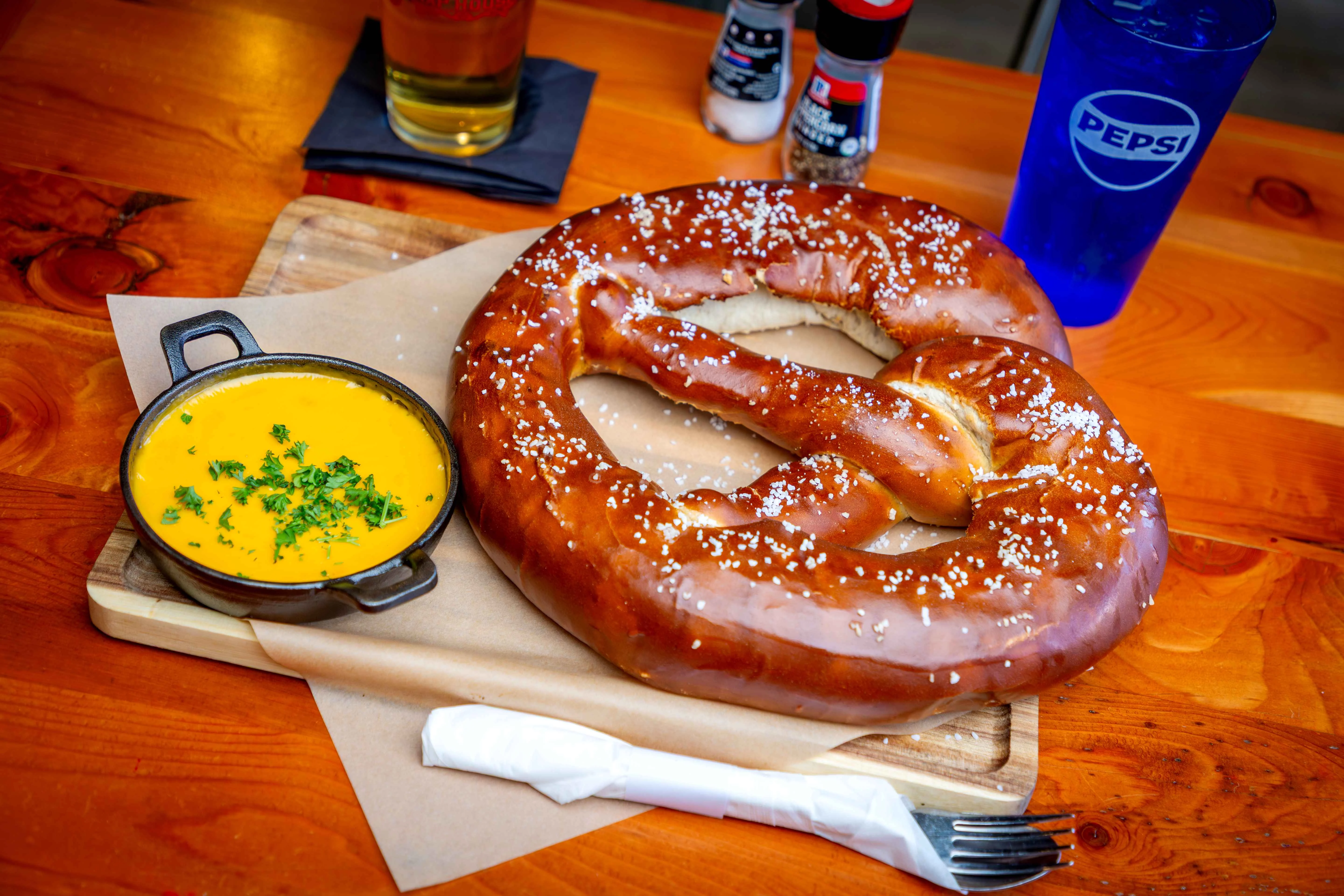 Giant soft pretzel with cheese dip, a classic German snack