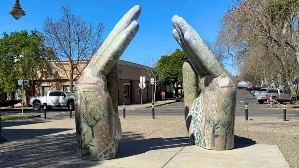 Artistic sculpture of hands in a public space