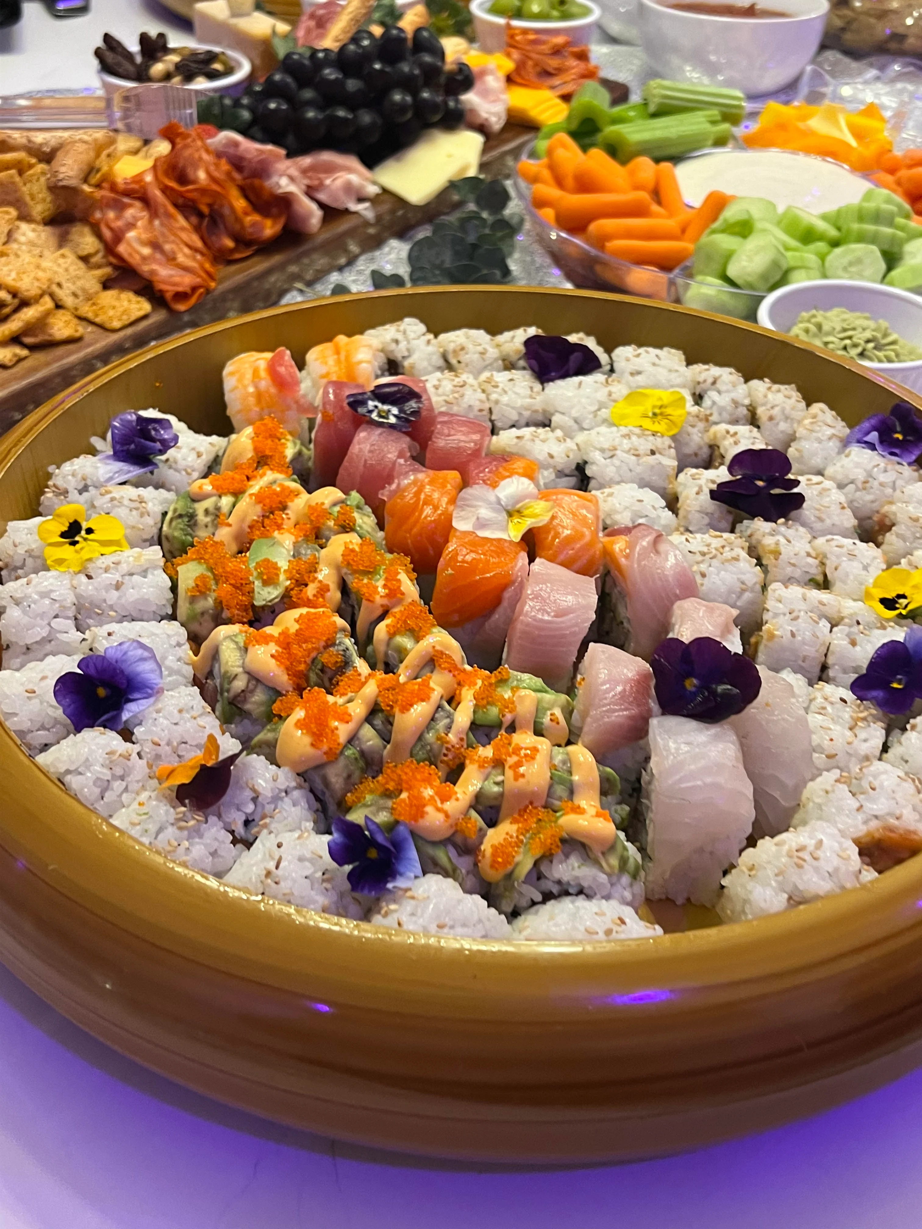 Assorted sushi platter featuring colorful rolls and sashimi