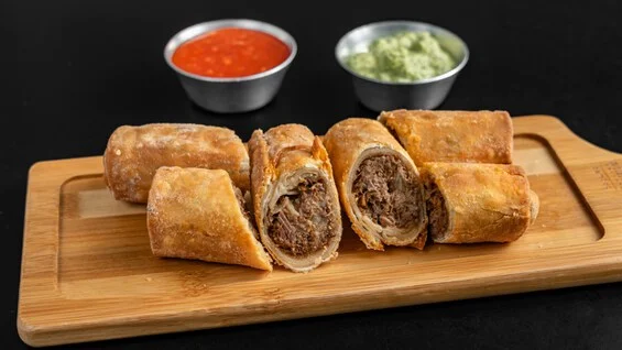 Crispy shredded beef flautas with salsa and guacamole