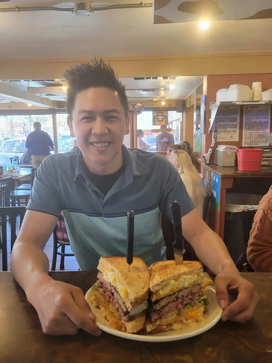 Giant double-decker burger in a casual diner setting