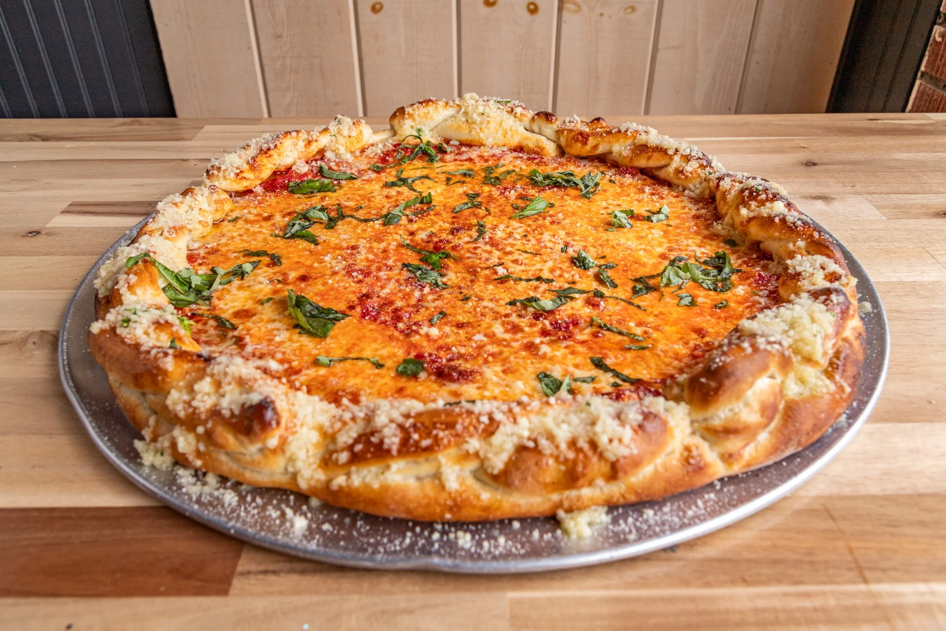 Cheesy stuffed crust pizza with fresh basil