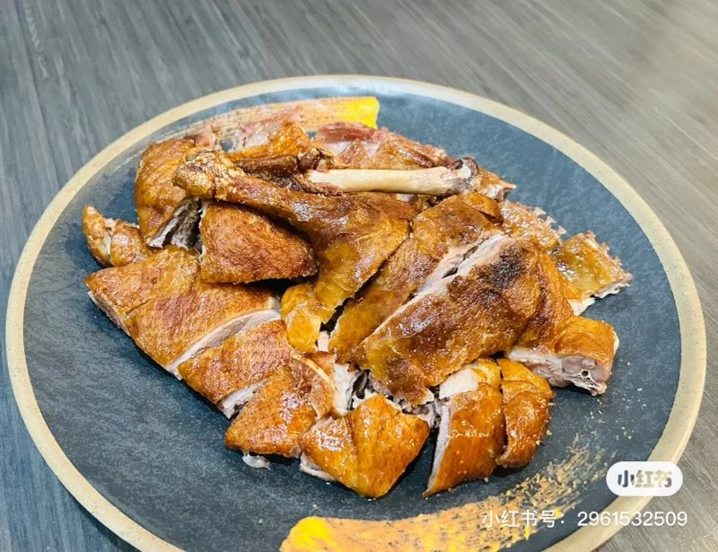 Crispy Chinese roast duck served on a black plate