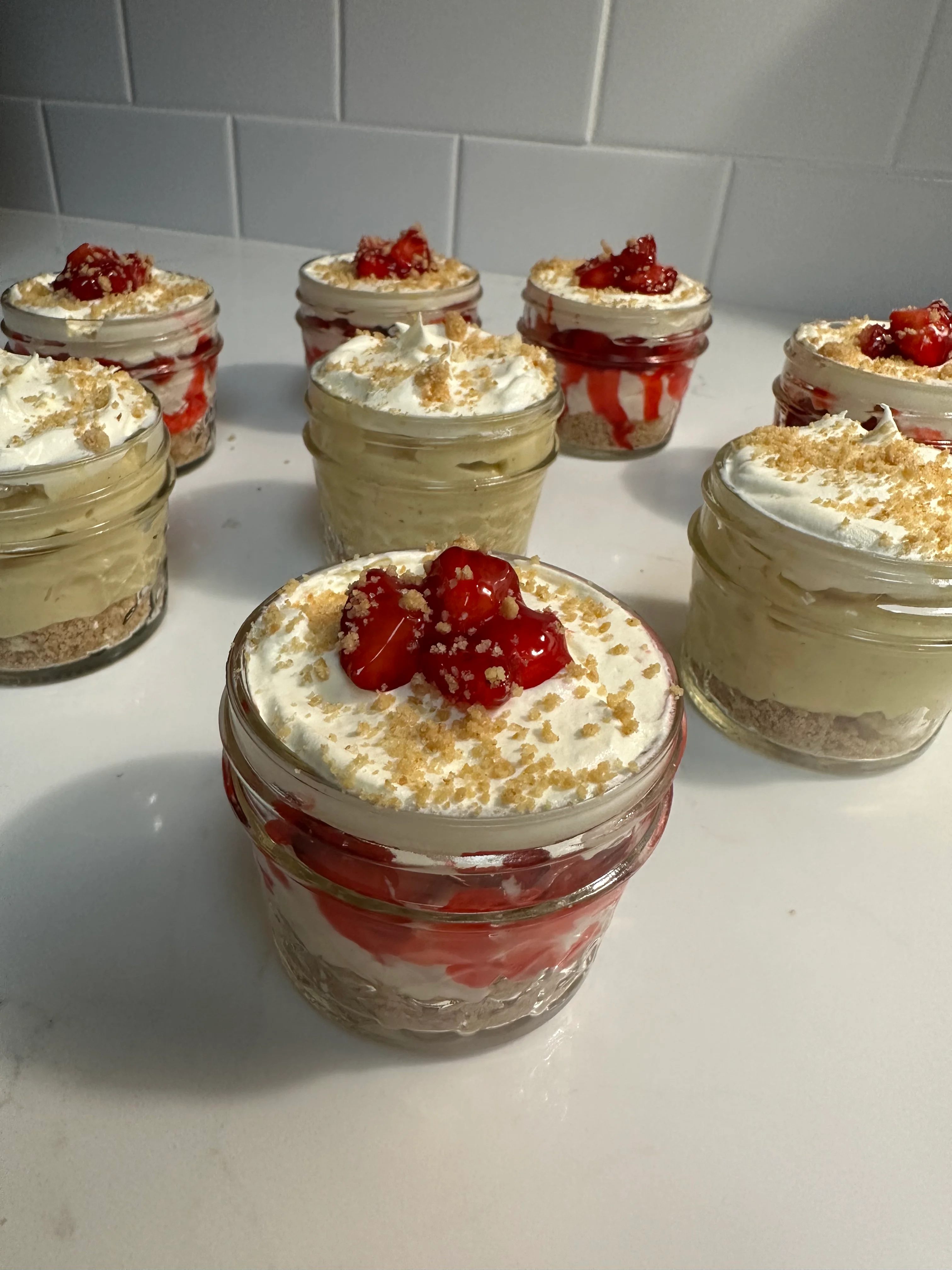Individual strawberry shortcake jars with whipped cream