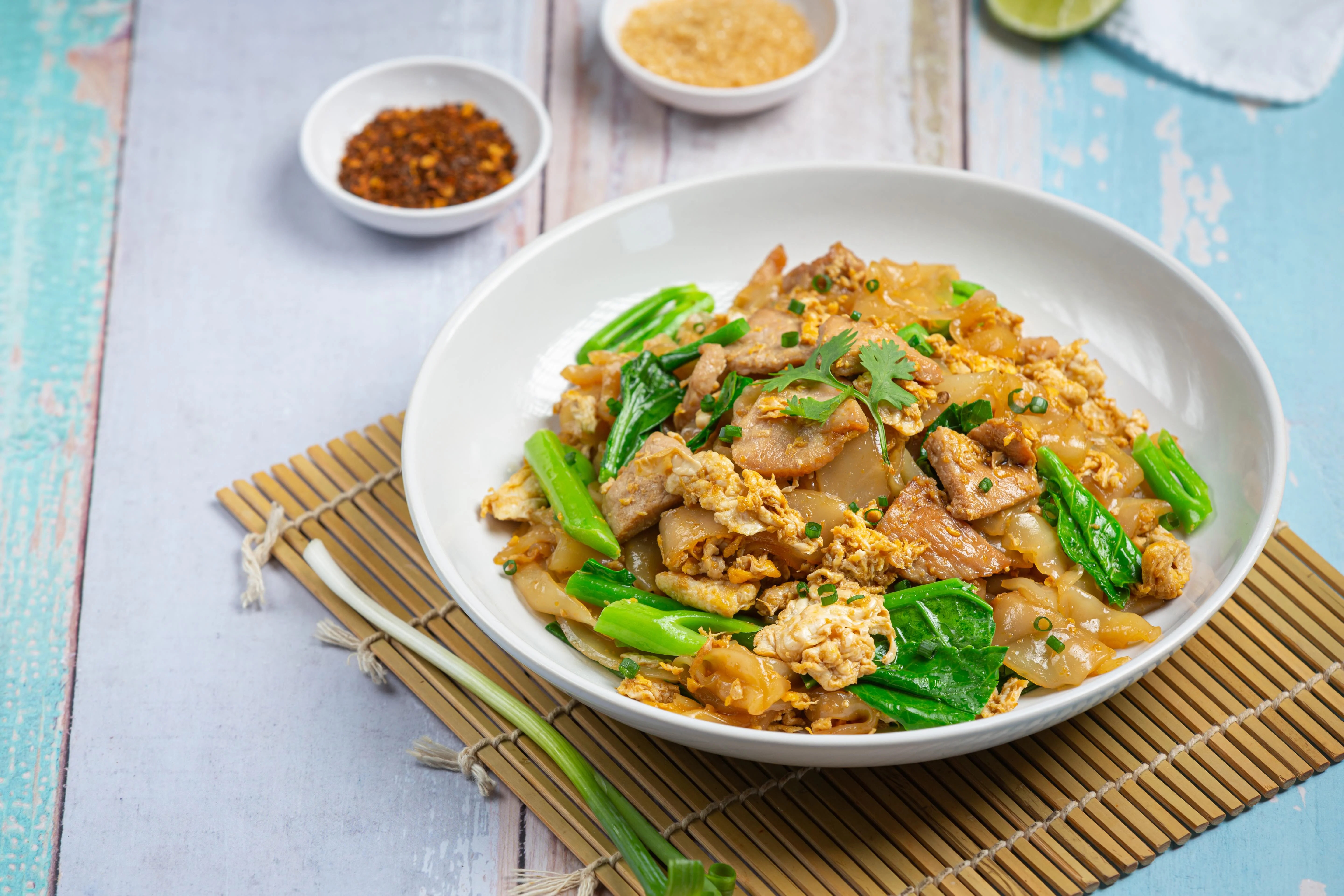 Plate of Thai pad see ew with chicken and vegetables