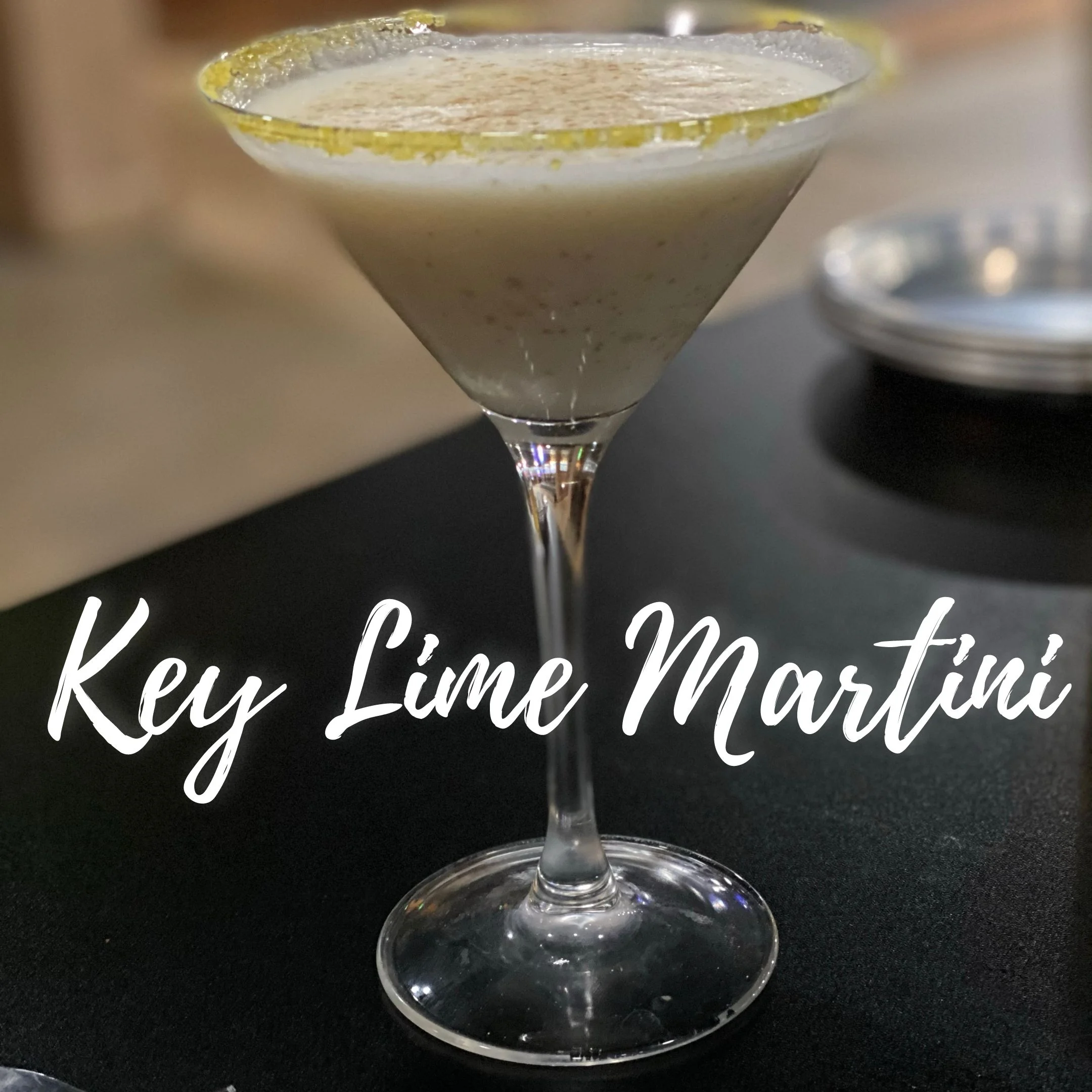 A refreshing key lime martini garnished with a lime slice.