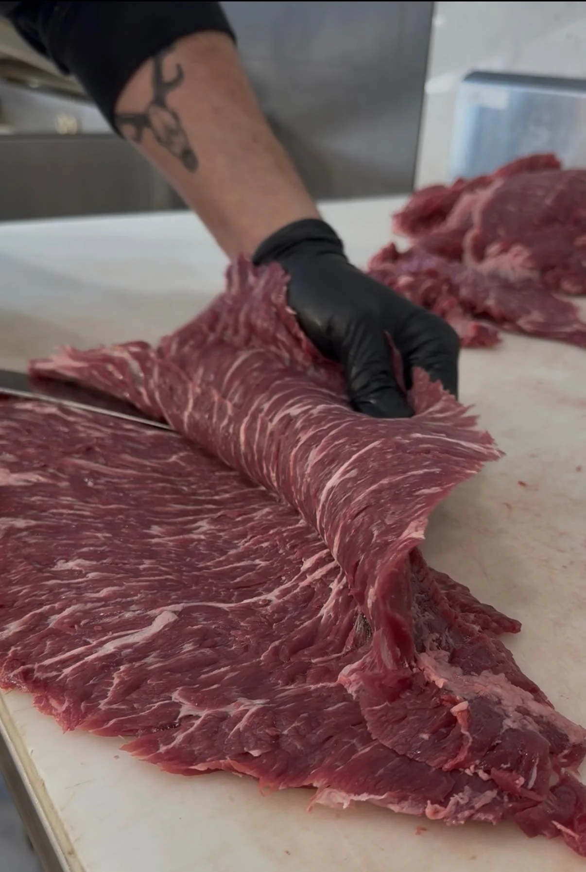 Butcher preparing marbled beef for cooking