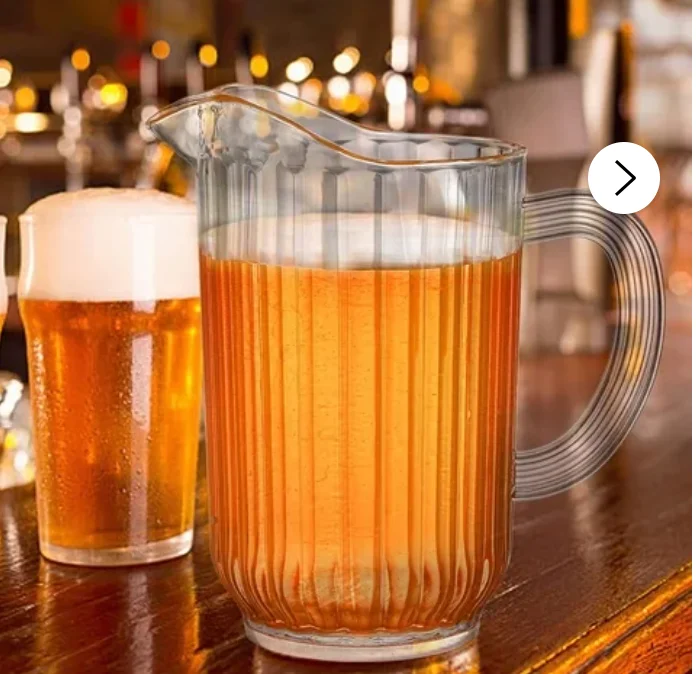 Pitcher of amber beer on a wooden bar