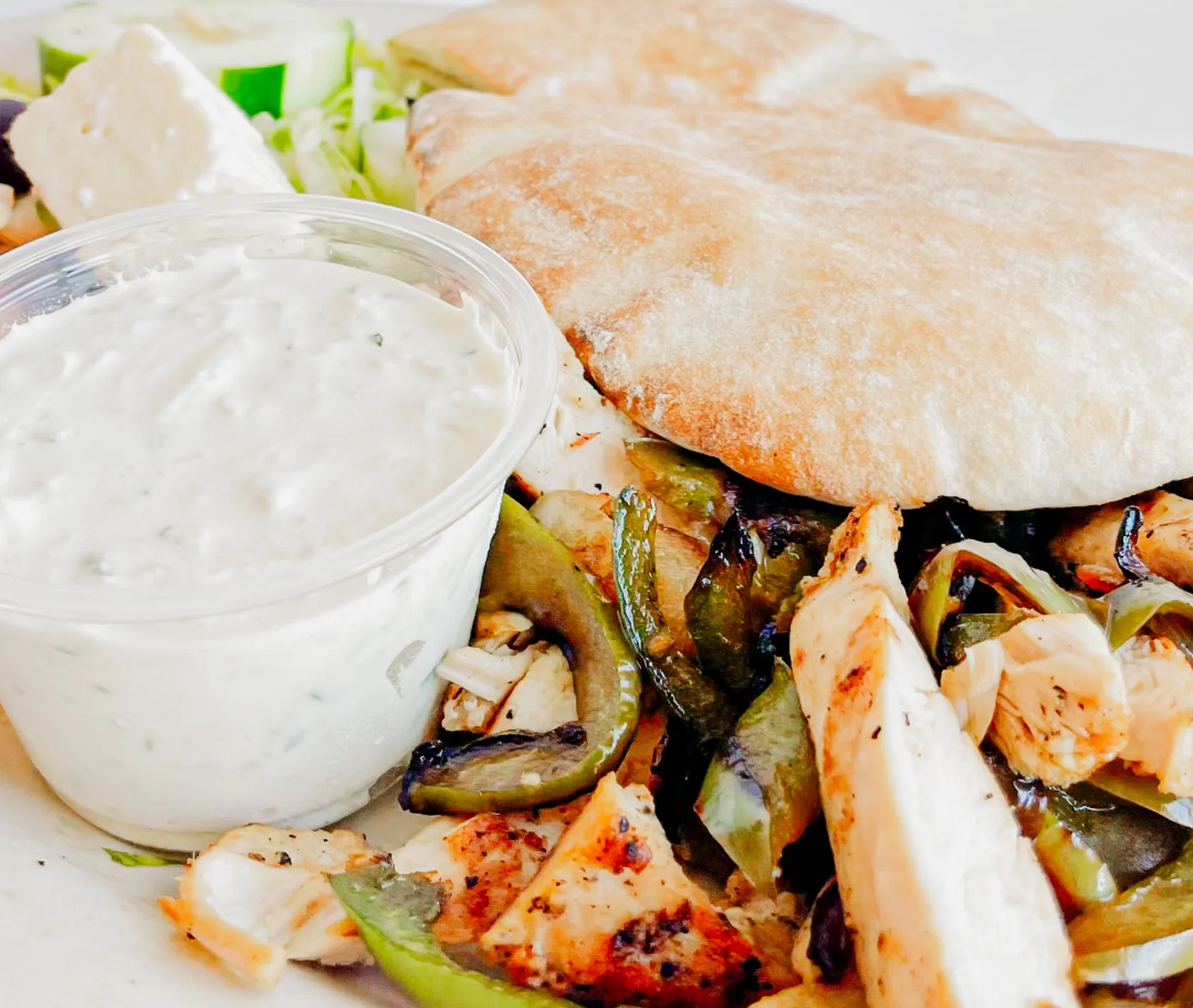 Grilled chicken shawarma platter with pita and tzatziki