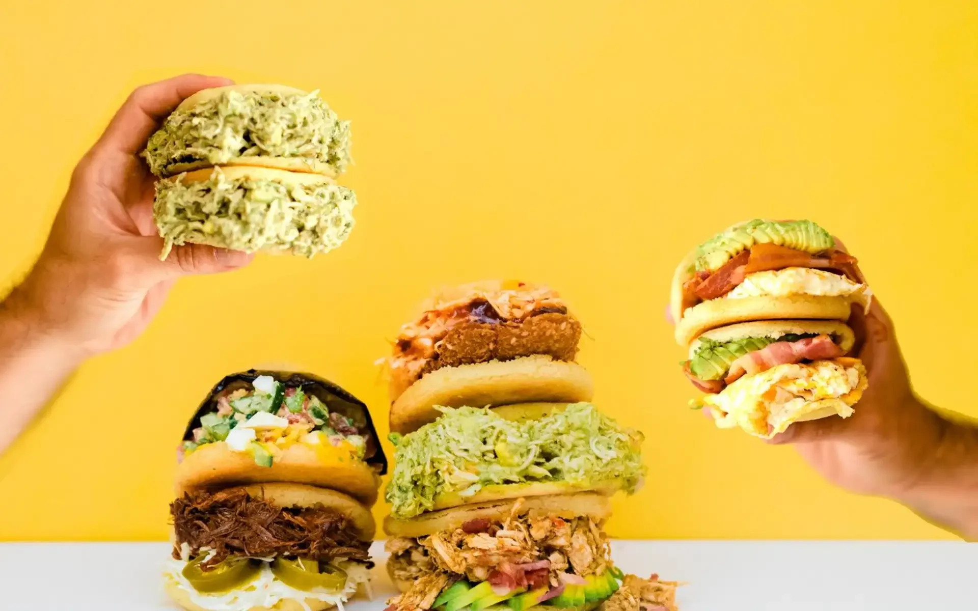 Colorful Mexican tortas stacked with various fillings