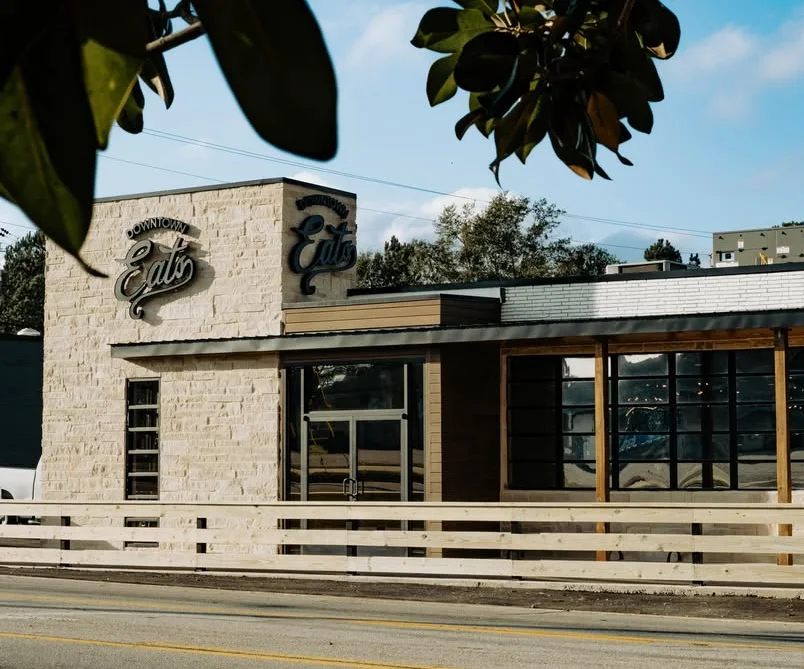 Modern restaurant exterior with wooden accents and large windows