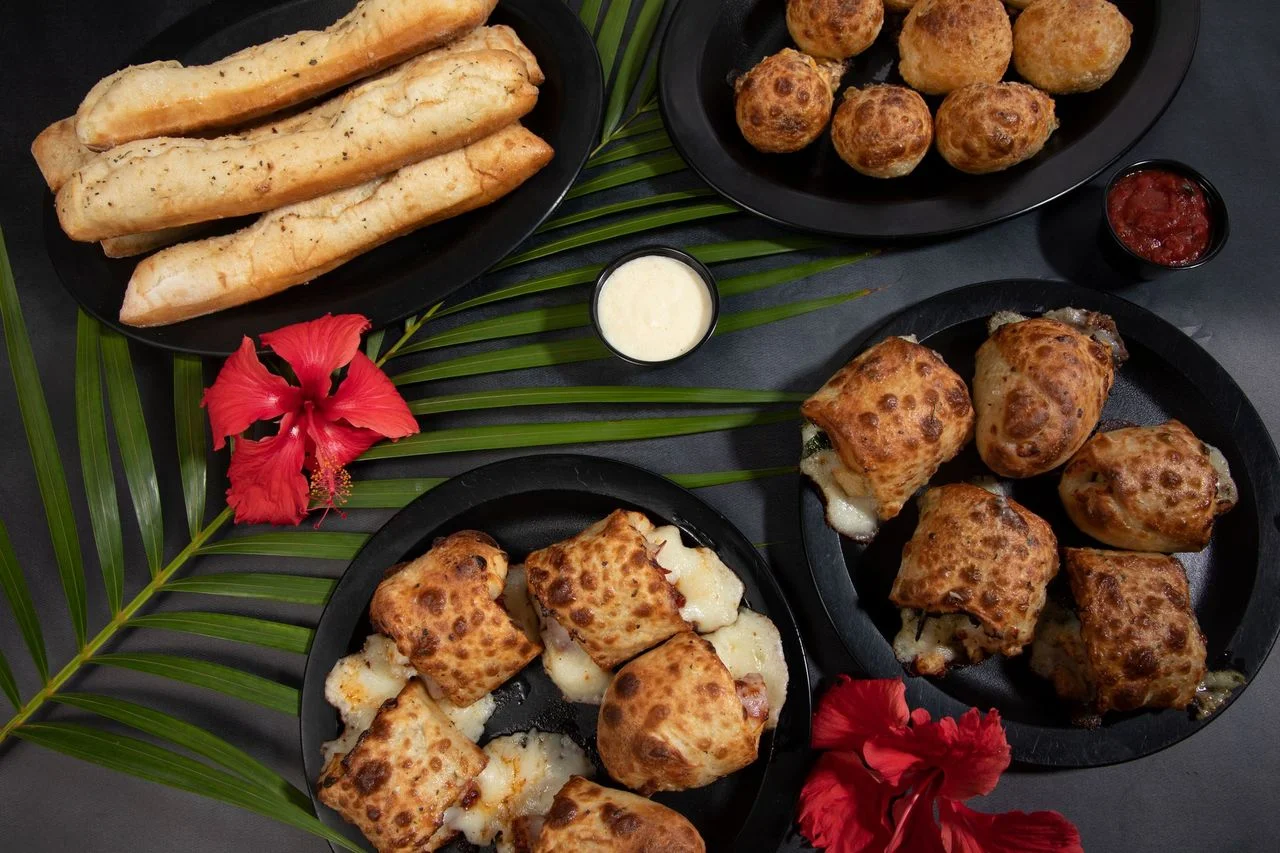 Cheesy stuffed bread rolls and garlic bread with dipping sauces