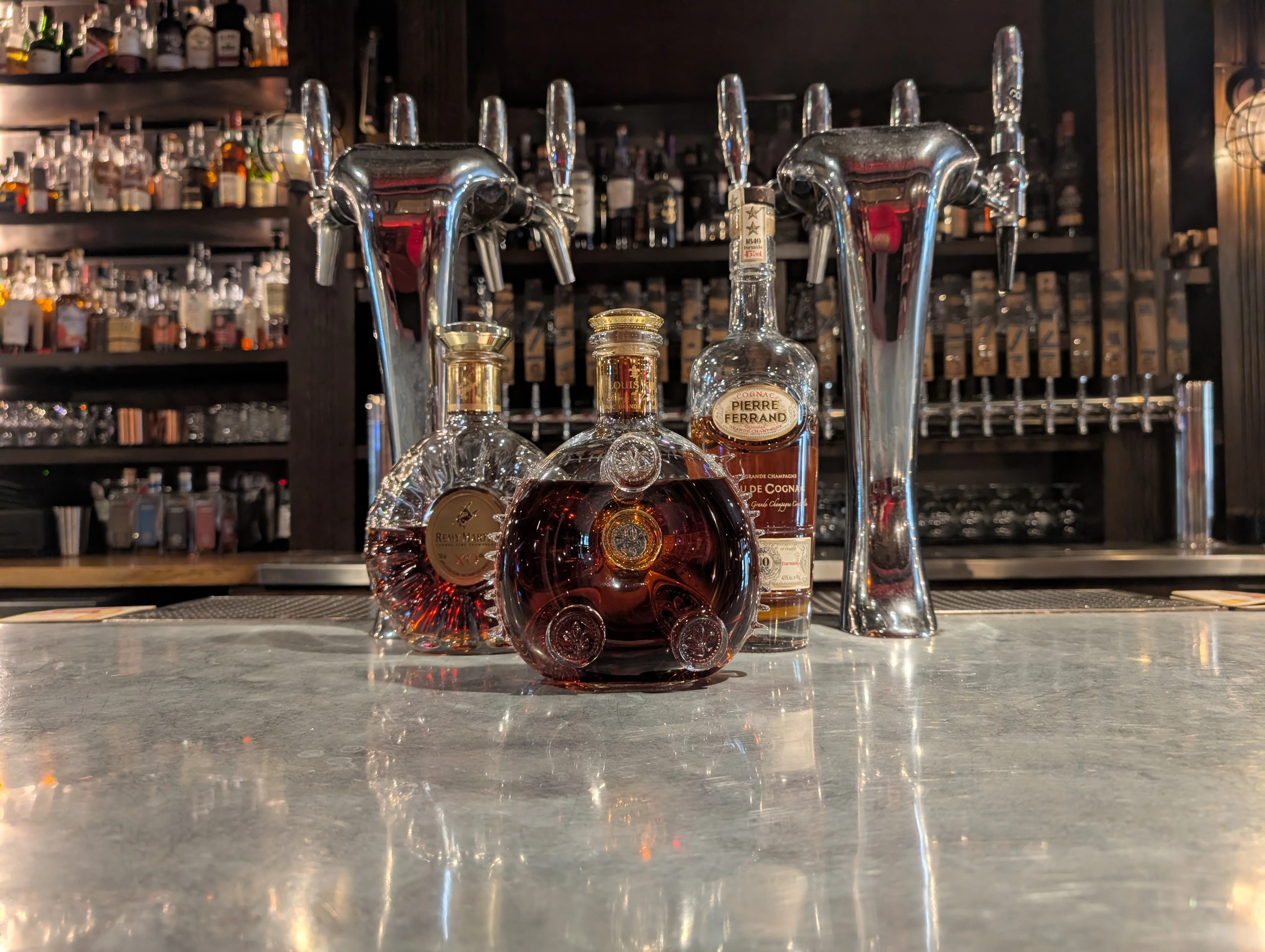 Selection of premium cognacs on a bar counter