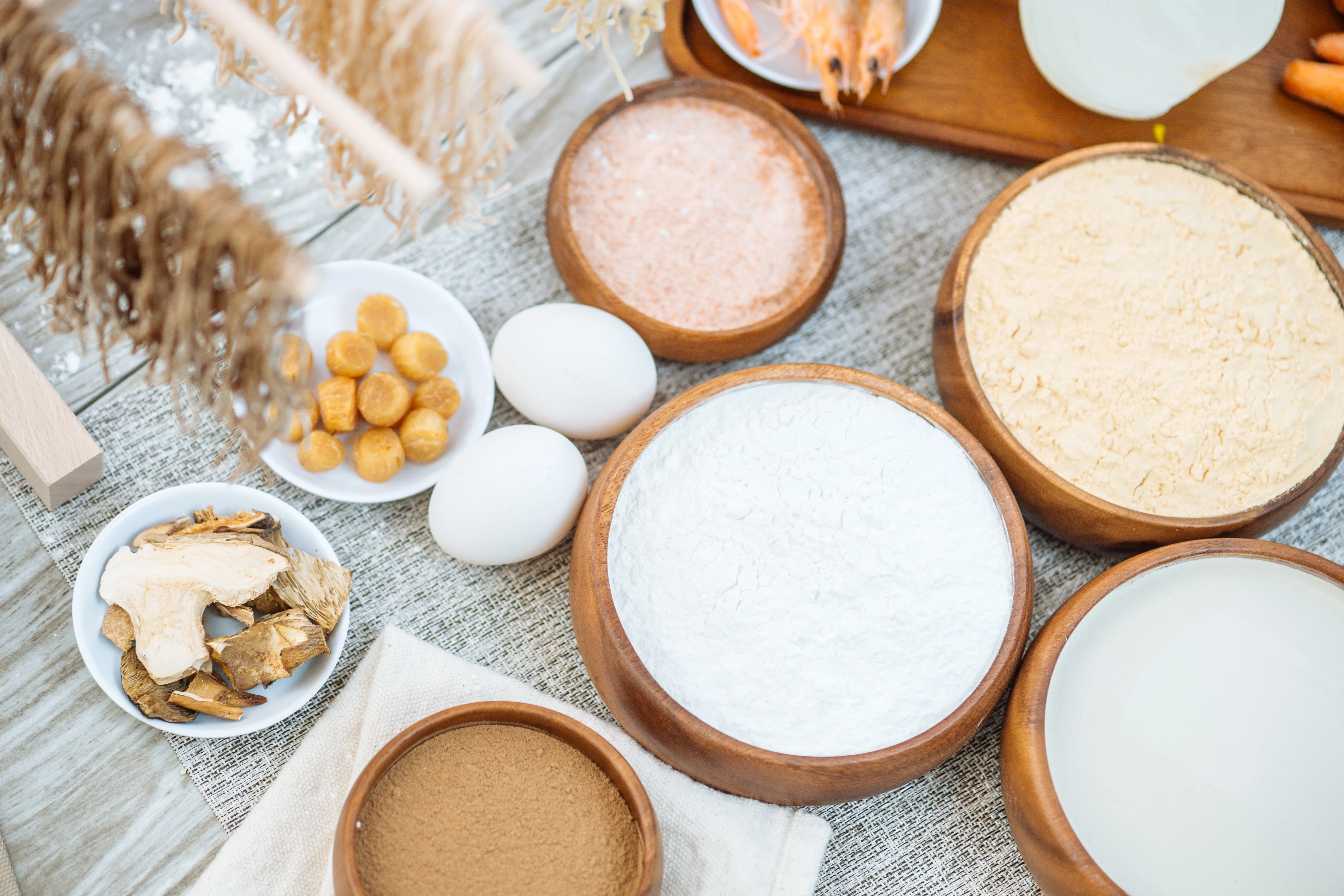 Assorted Asian cooking ingredients in wooden bowls